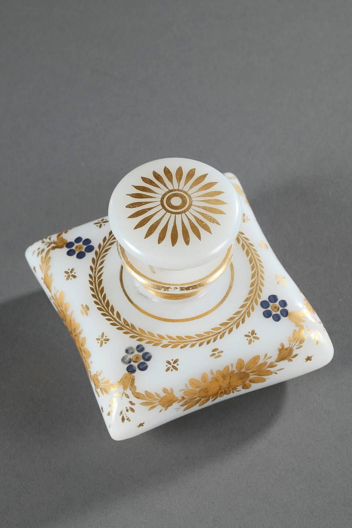 White, opaline crystal flask and its flattened stopper, decorated with a gilded, radiant flower on top. Gilded stripes surround the collar, and a ring of laurels, garlands of roses, and blue forget-me-nots embellish the body of the flask. Produced