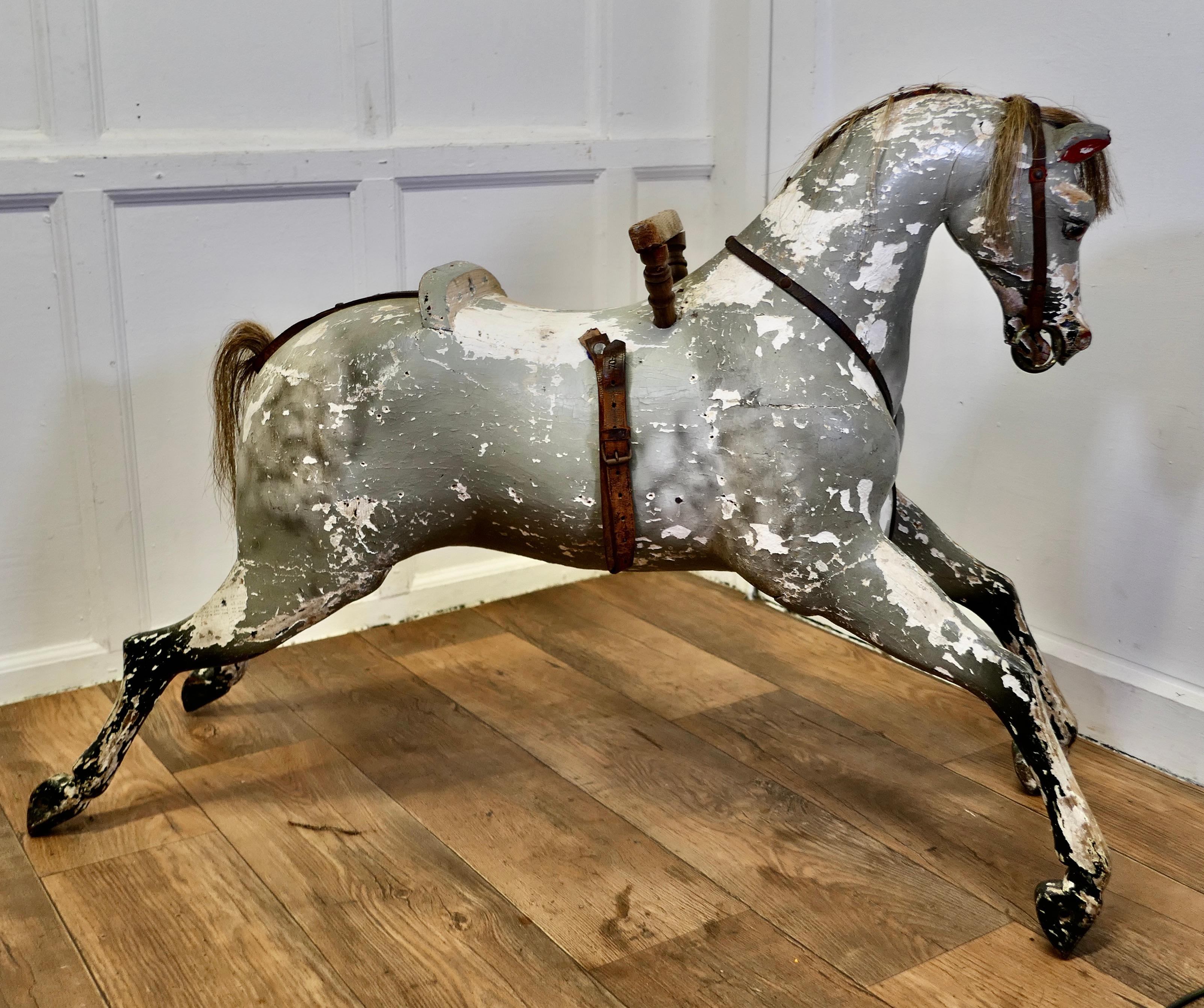 Early 19th Century Wooden Horse

A handsome Dapple Grey galloper with Horse Hair mane and tail, he has a classic open mouthed expression and bright glass eyes
Our Handsome galloper has a very shapely muscular body and his head tilts slightly to one