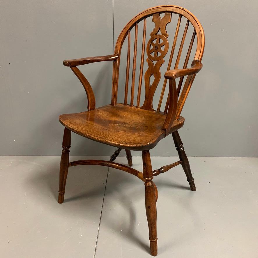 Lovely early 19th century yew and elm low back Windsor armchair with crinoline stretcher and carved wheel splat back.
Lovely chair and very comfortable with a fabulous color tone too.
Good condition throughout and showing an interesting aged