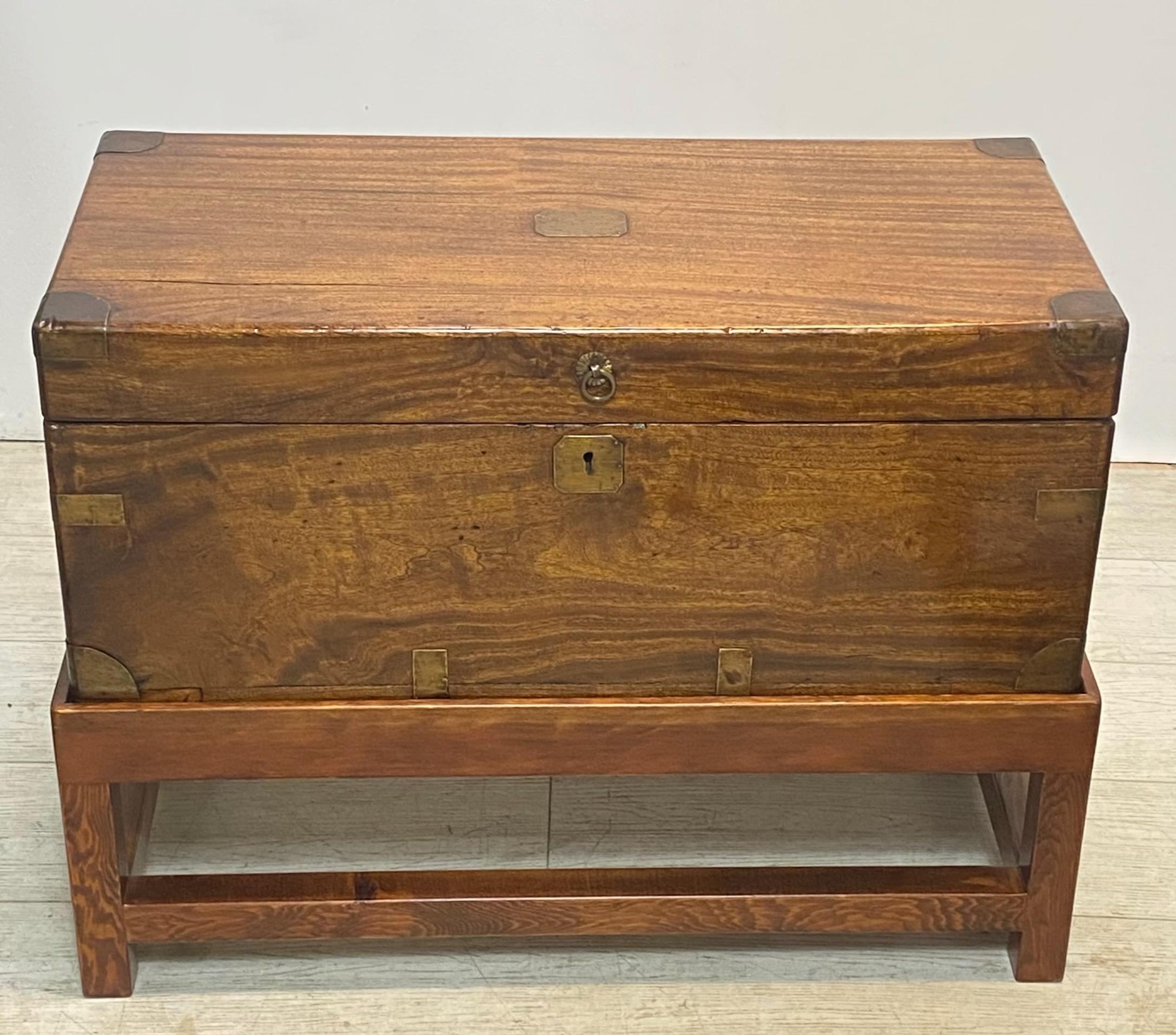 An unusual size camphor wood trunk on custom made stand with original brass straps, corners and handles, the hinged lid opening to reveal a large compartment space.
In excellent antique condition with original finish.
Ideal for use as a coffee