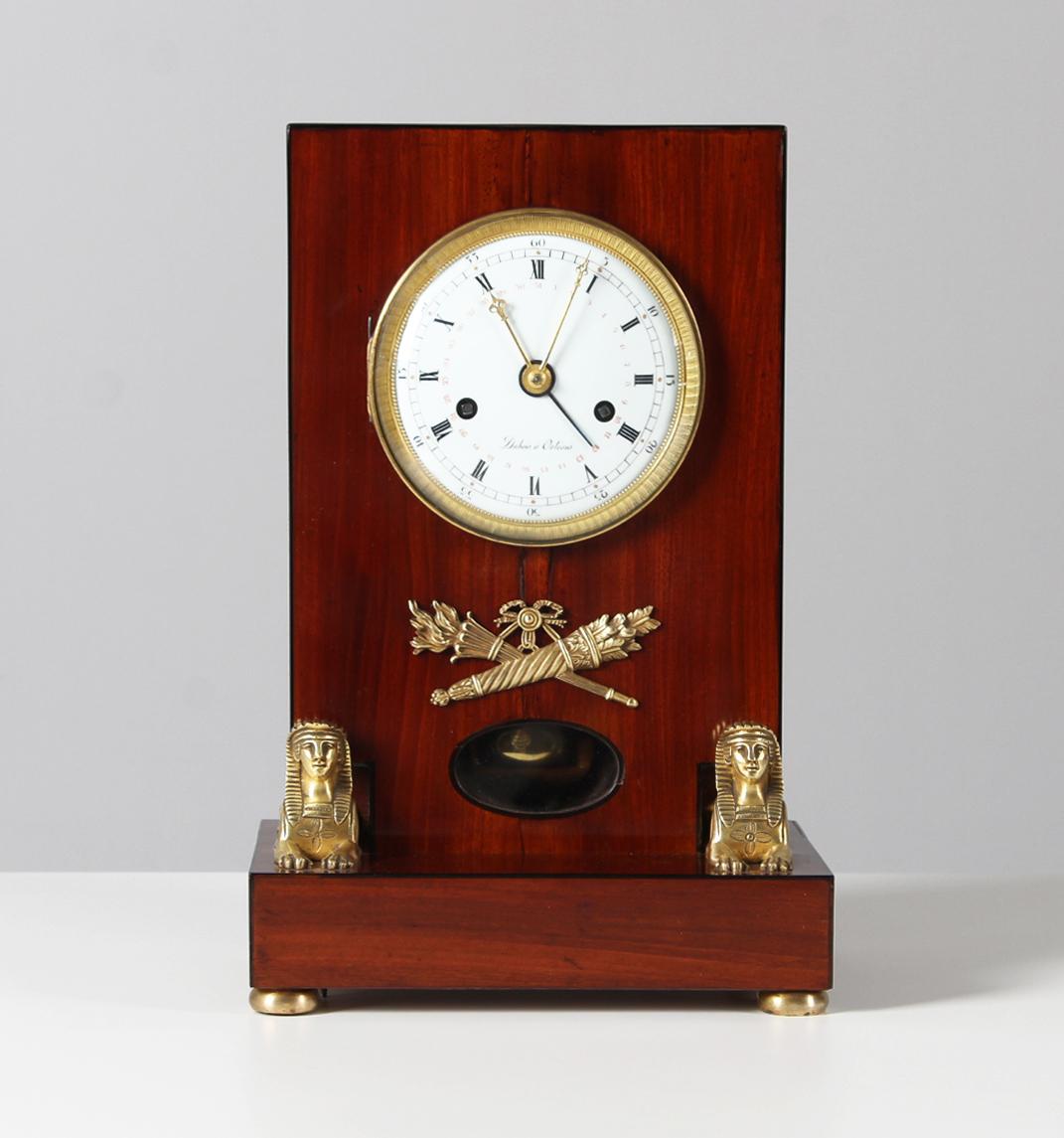 Empire mantel clock with calendar

France
mahogany
early 19th century

Dimensions: H x W x D: 35 x 24 x 17 cm

Description:
Beautiful antique Empire mantel clock in mahogany case. So-called Pendule d'Audience.

Pedestal standing on four