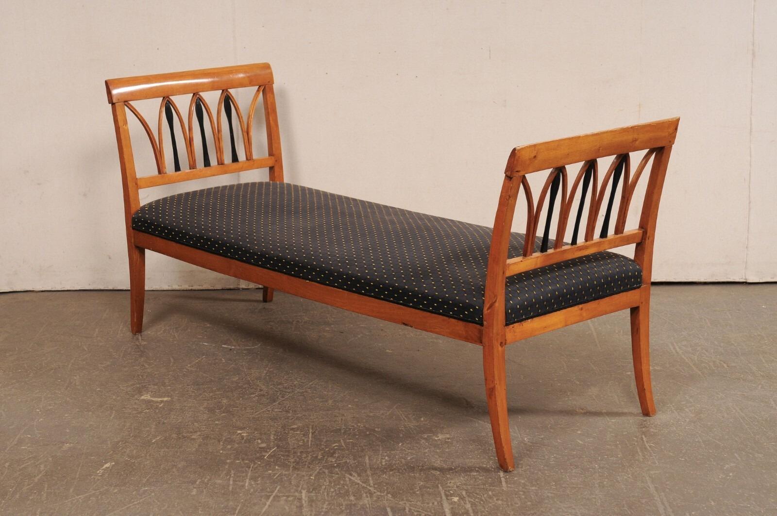 A Swedish Karl Johan (Biedermeier) carved-wood sofa bench, with upholstered seat, from the early 19th century. This period Karl Johan bench comes from the Lindome region of Sweden; a region known for master craftsman in wood working. This backless