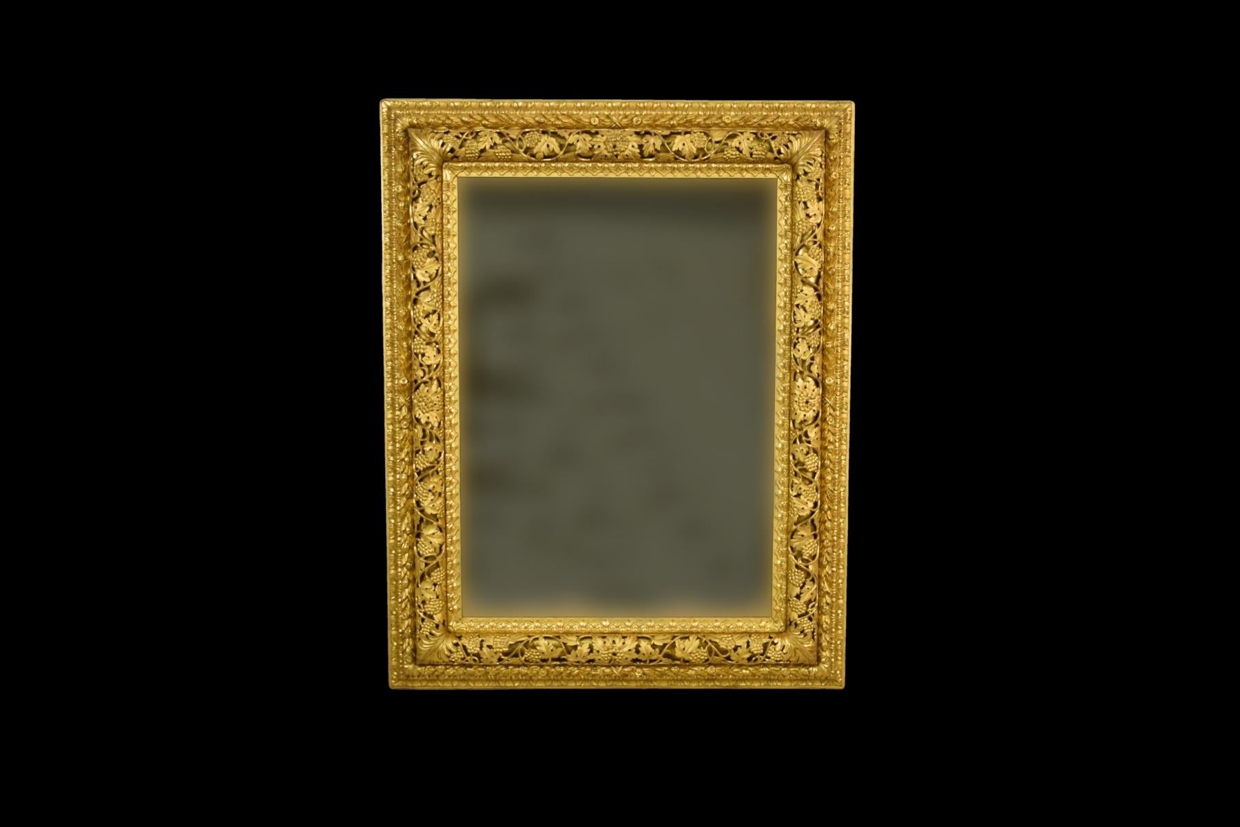 This beautiful rectangular mercury mirror in carved and gilded wood frame was made in the early 19th century in Venetian area of Italy. The richly carved frame is characterized by a shape called 