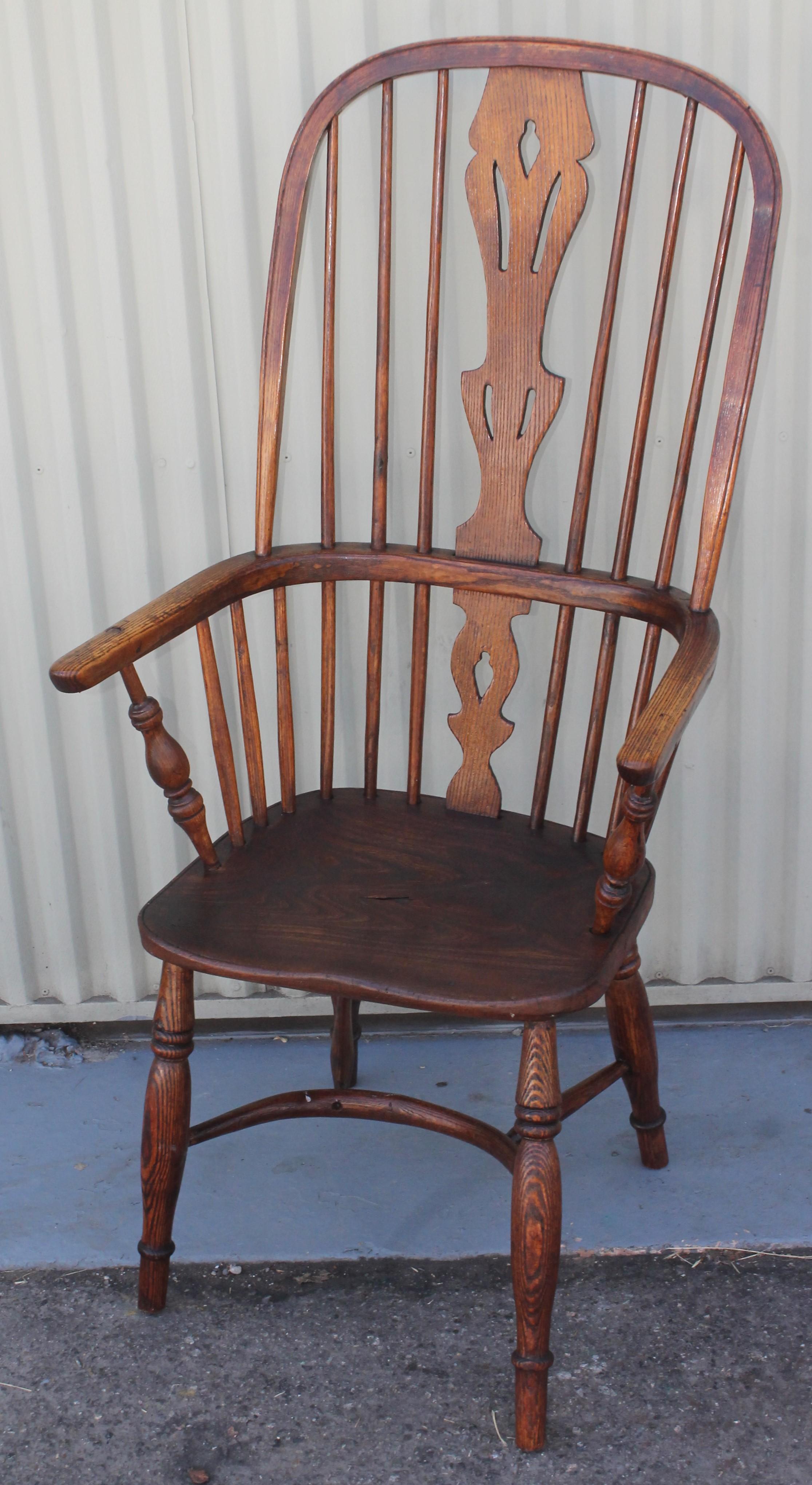 This fine English Windsor armchair has a amazing untouched patina and looks a little off center from age and use. The condition is good with marks and wear consistent from age and use. Its a handmade and carved chair so it is not perfectly centered.