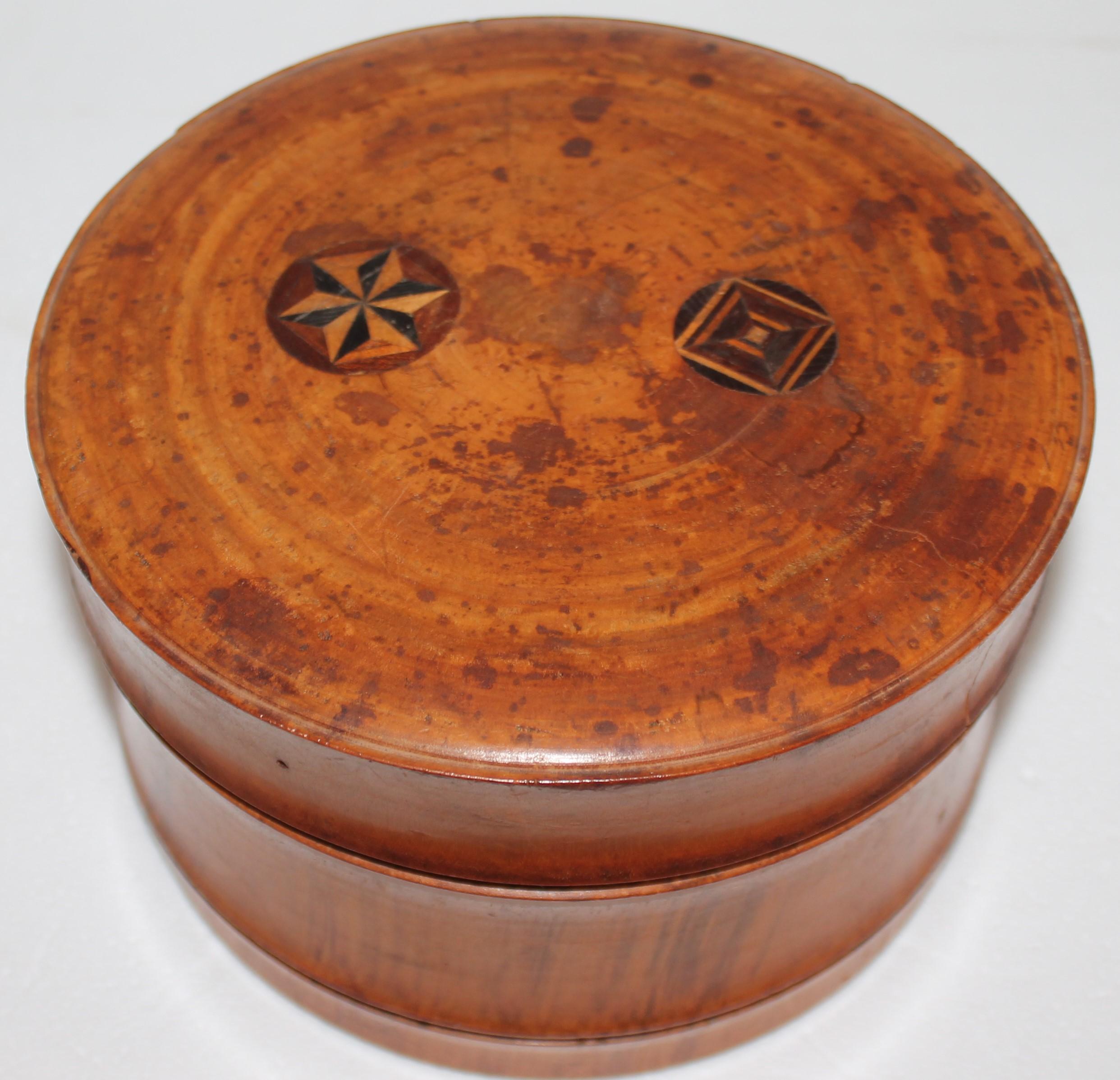 Early 19thc hand carved wood canister inlaid bottom & top.