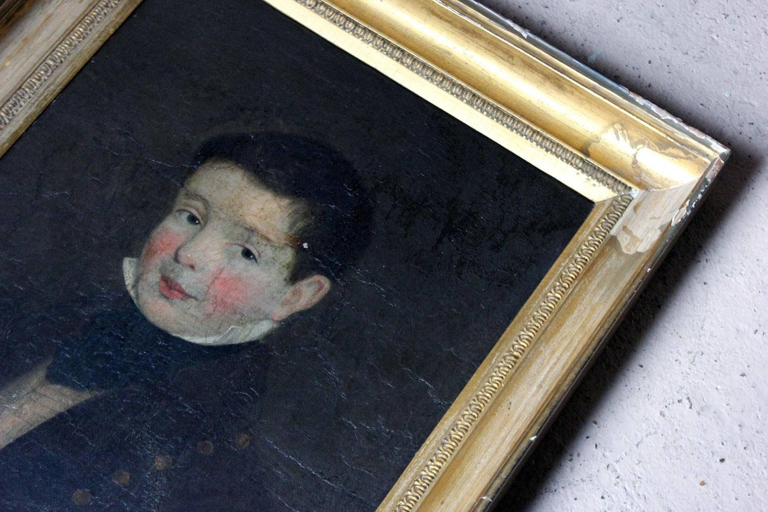 The Irish school depiction of a smart young boy in oils on board, of around eight to ten of years of age, shown in bust length, presented in its original deep moulded gilded frame, the sitter with green eyes, rosy cheeks and a sweet smile, wearing