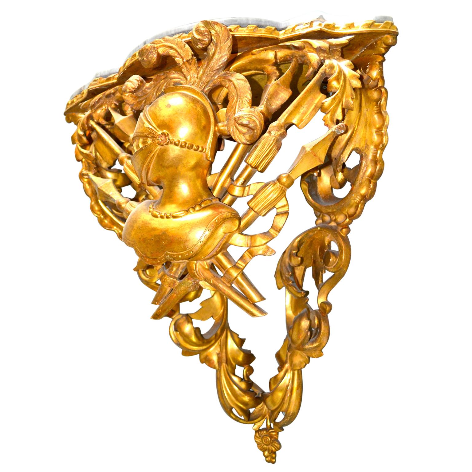 A finely carved and water gilt pine Italian corner bracket displaying period Empire military attributes. In front of the curved middle section, (of three), is a large feathered helmet behind which are vertical spears, fascia etc. The two lower