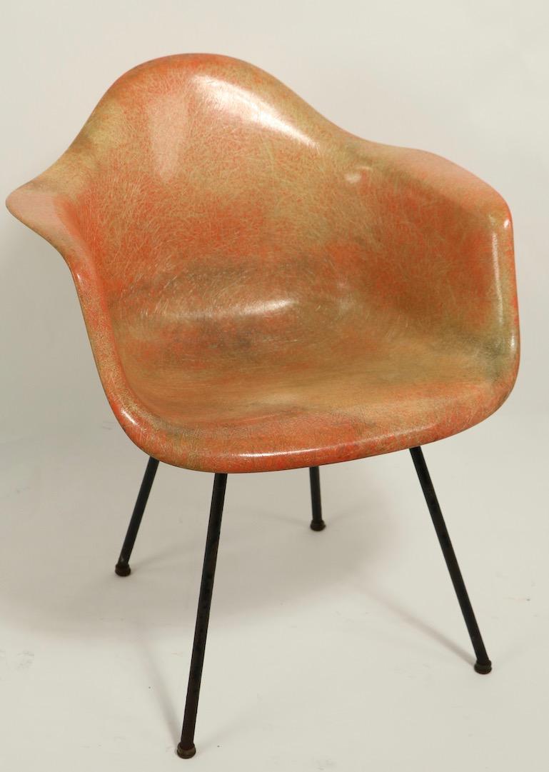 Rare 1st generation Eames rope edge fiberglass SAX chair in translucent fiberglass, having the large rubber bumpers, X base, and domes of silence glide feet. The chair shows significant discoloration, but no cracks, chips, or structural damage. It
