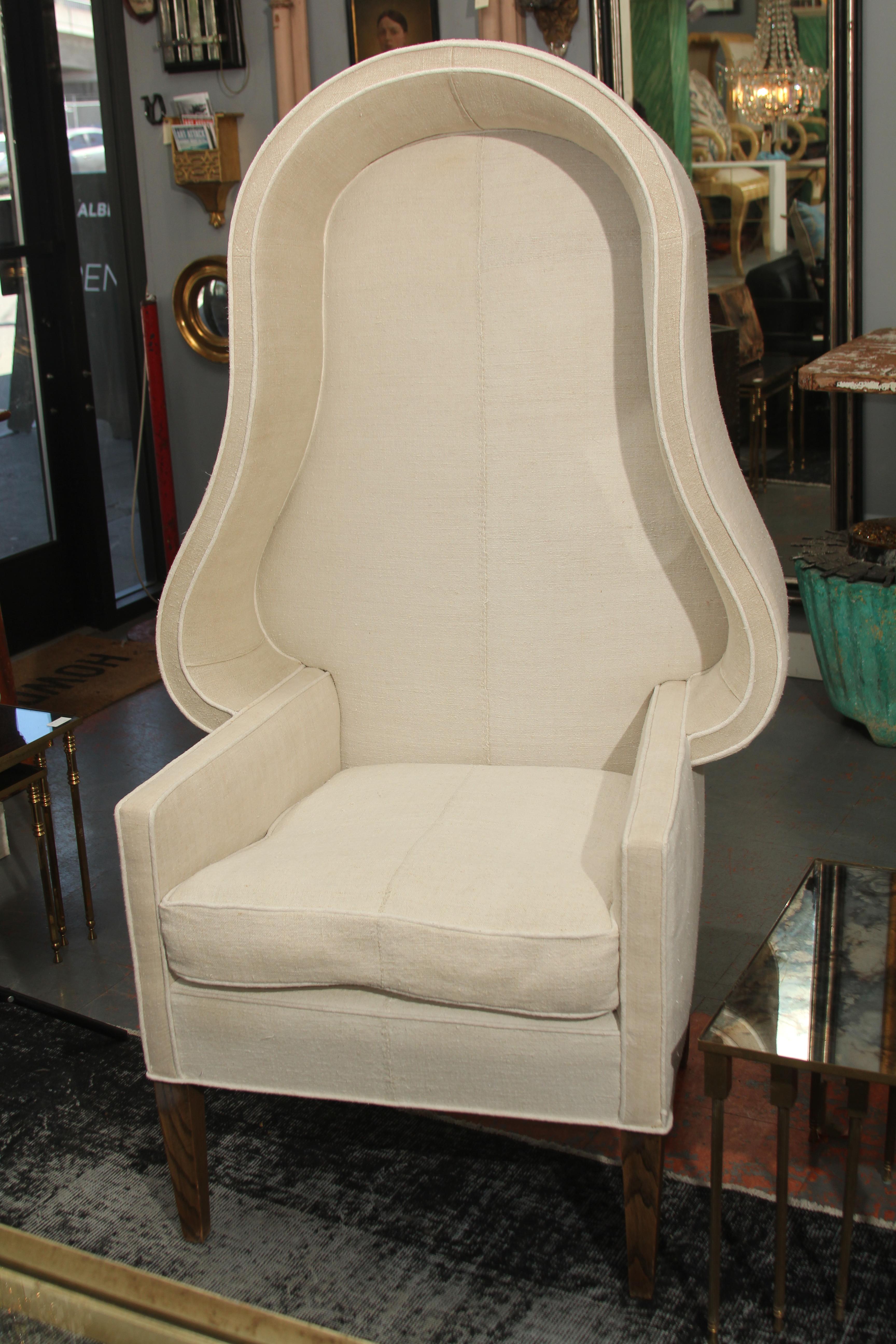 Sleek design and curves on this early 20th century Porters chair make it a piece of sculpture as well as functional seating. Simple, strong modern lines reupholstered in late 19th century homespun linen. Feather cushion.
 