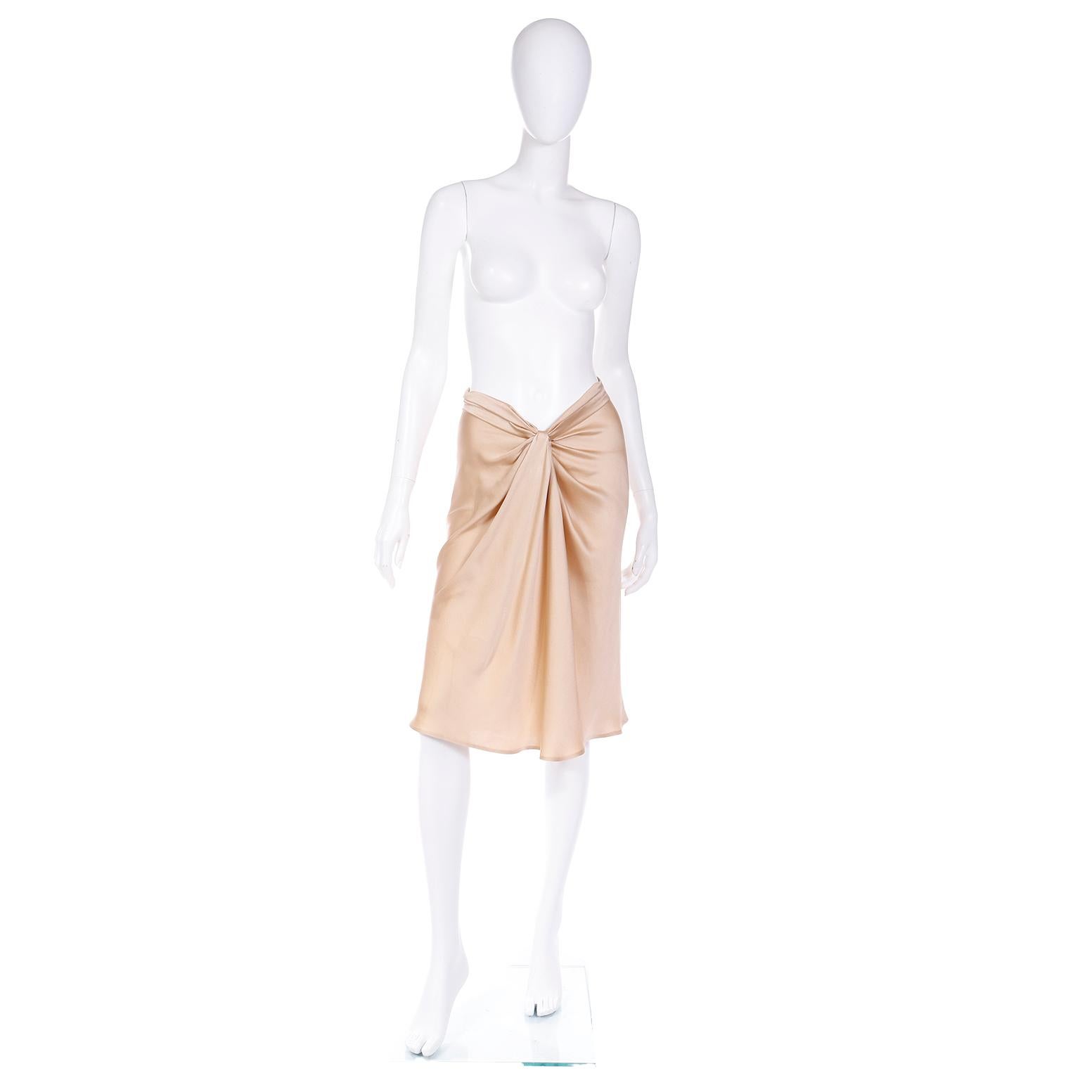 This is an Alberta Ferretti quintessential early 2000's  soft gold luxe silk charmeuse skirt with a uniquely gathered v shape high low waist. This incredible skirt has so many unique details including the interesting tucks in the back. The skirt