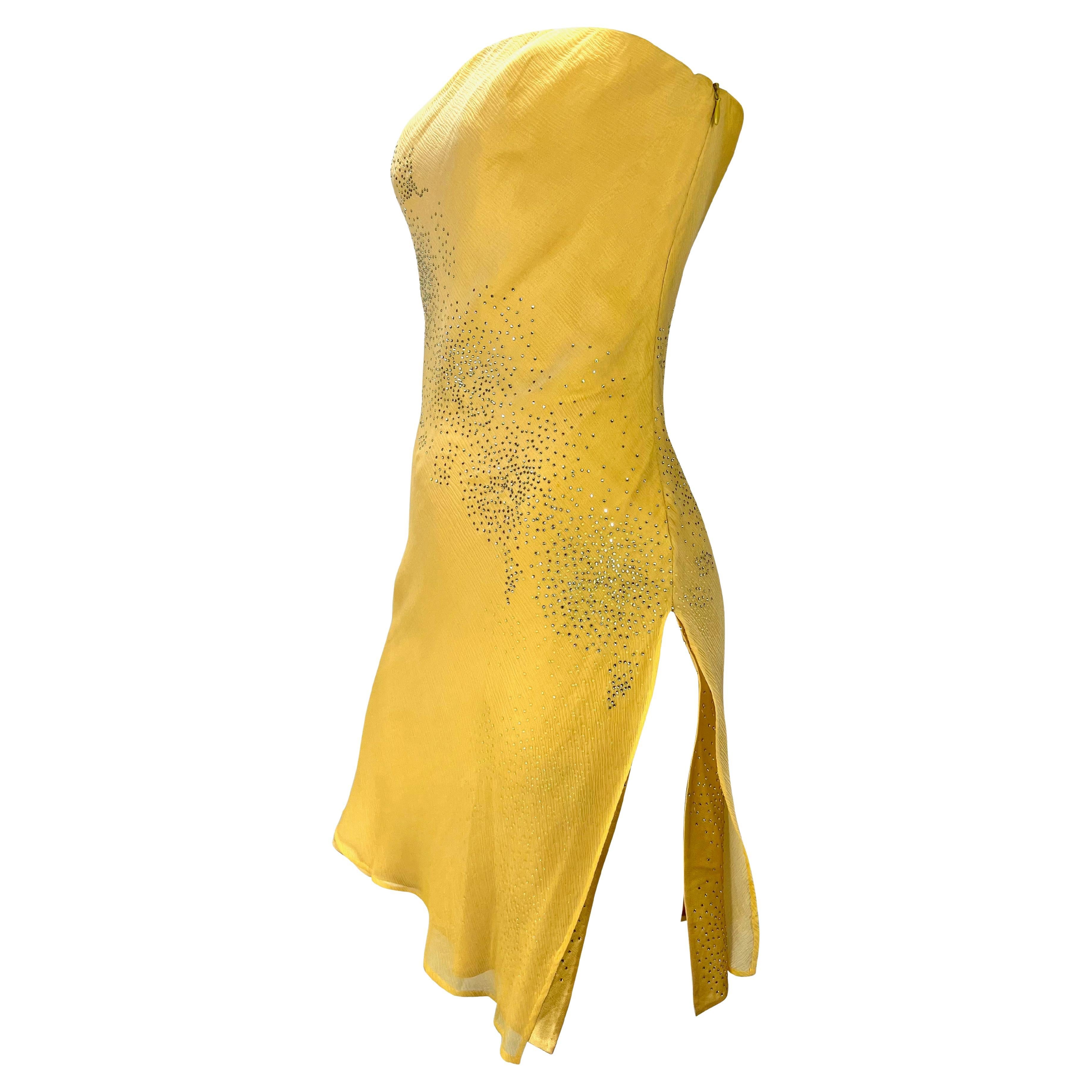 Presenting a stunning light yellow strapless Atelier Versace mini dress, designed by Donatella Versace. From the early 2000s, this ultra-sexy mini dress is constructed of light yellow chiffon and is accented with rhinestones scattered throughout.