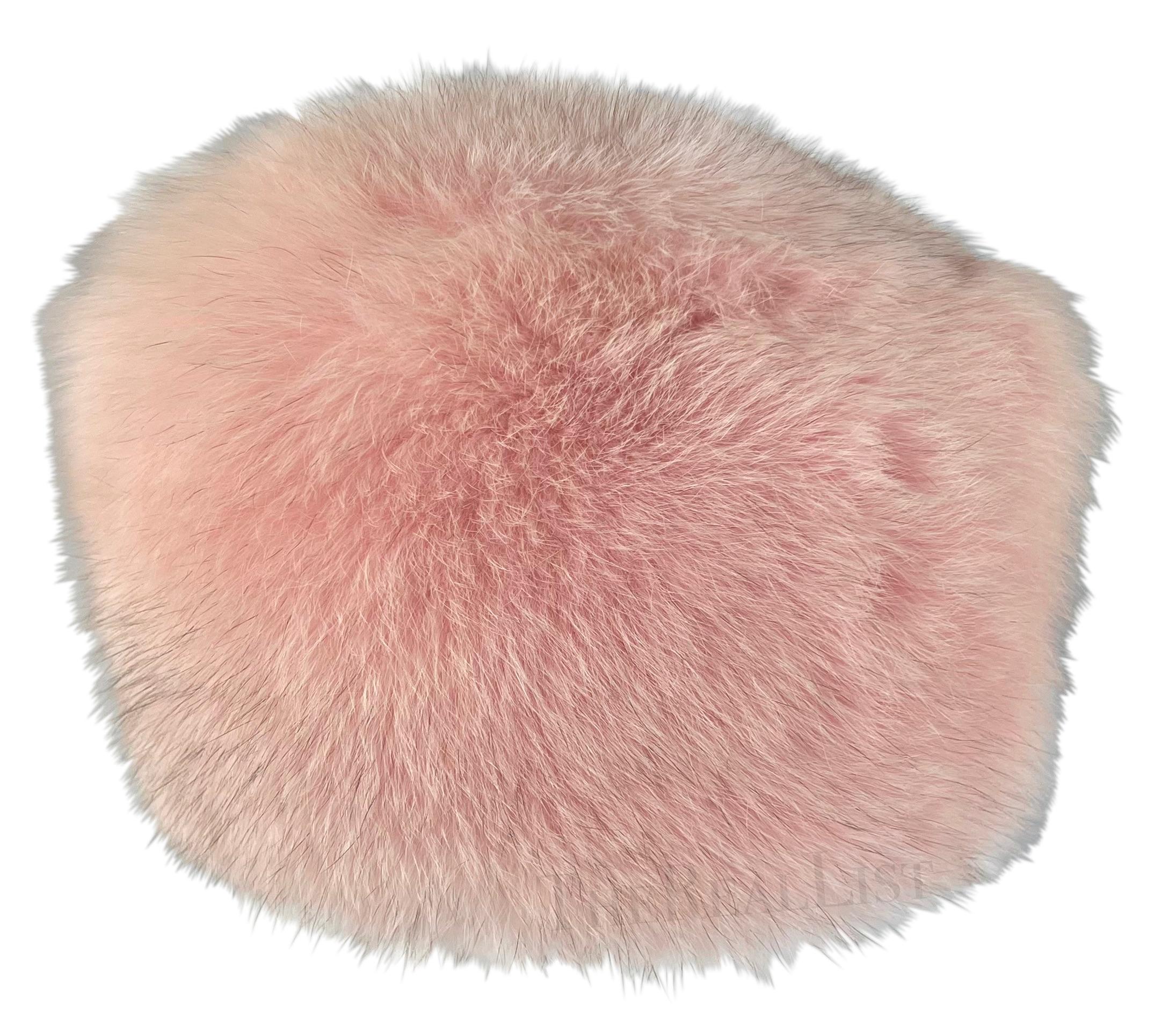 Presenting a perfectly pink Burberry London fox fur hat. From the early 2000s, this light pink pillbox-style hat exudes elegance and sophistication. Crafted entirely from fox fur, it offers both warmth and style. Whether hitting the slopes or