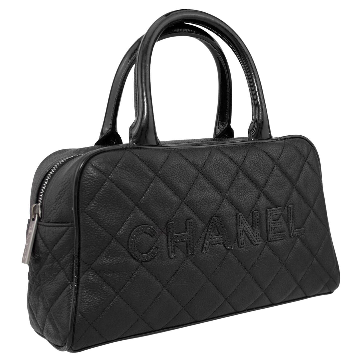 Designed between 2000-2002 by Karl Lagerfeld, this is a black quilted caviar leather mini bowler bag. Contrasting patent leather trim and top handles. Caviar leather is durable and water resistant, meant to imitate the look of exotic skin. Patent
