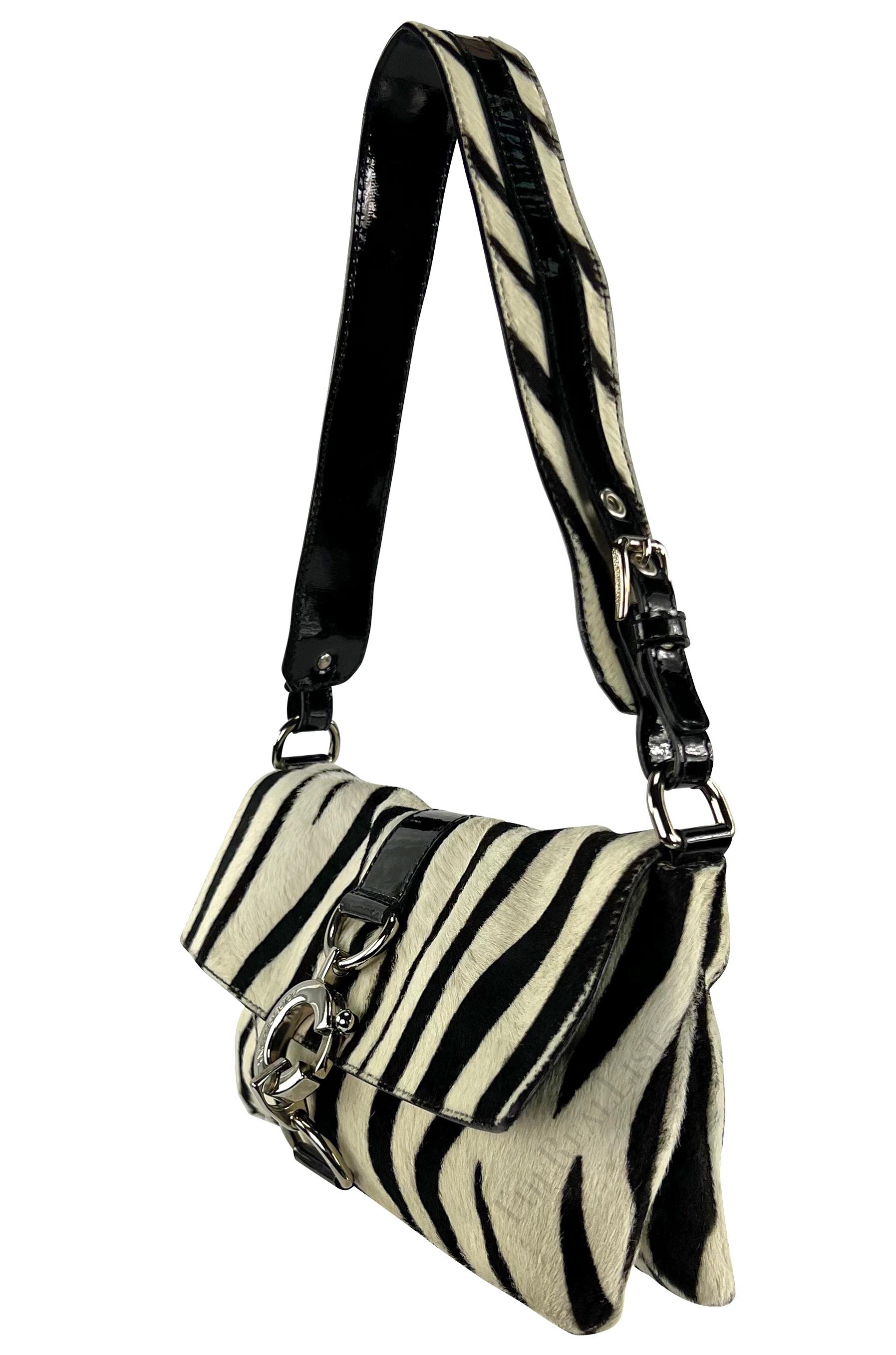Presenting a fabulous zebra print Dolce & Gabbana pony hair shoulder bag. From the early 2000s and constructed of pony hair, the bag boasts a timeless black and white zebra pattern, complemented by refined silver-tone hardware and patent leather