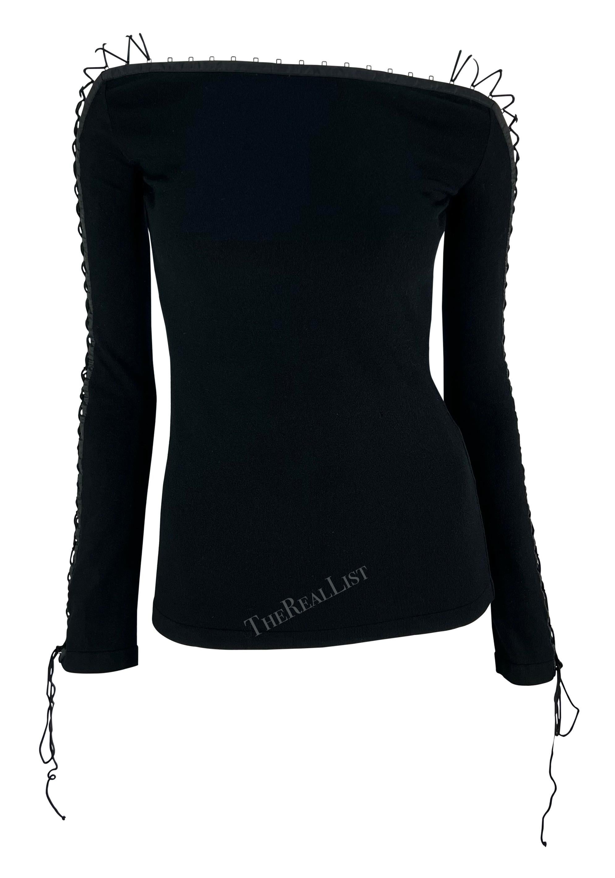 From the early 2000s, this fabulous black knit Dolce & Gabbana lace sweater is elevated with a lace-up detail that runs up both sleeves. This sultry sweater is made complete with a bateau neckline and cords that ties at the wrist. Add this chic