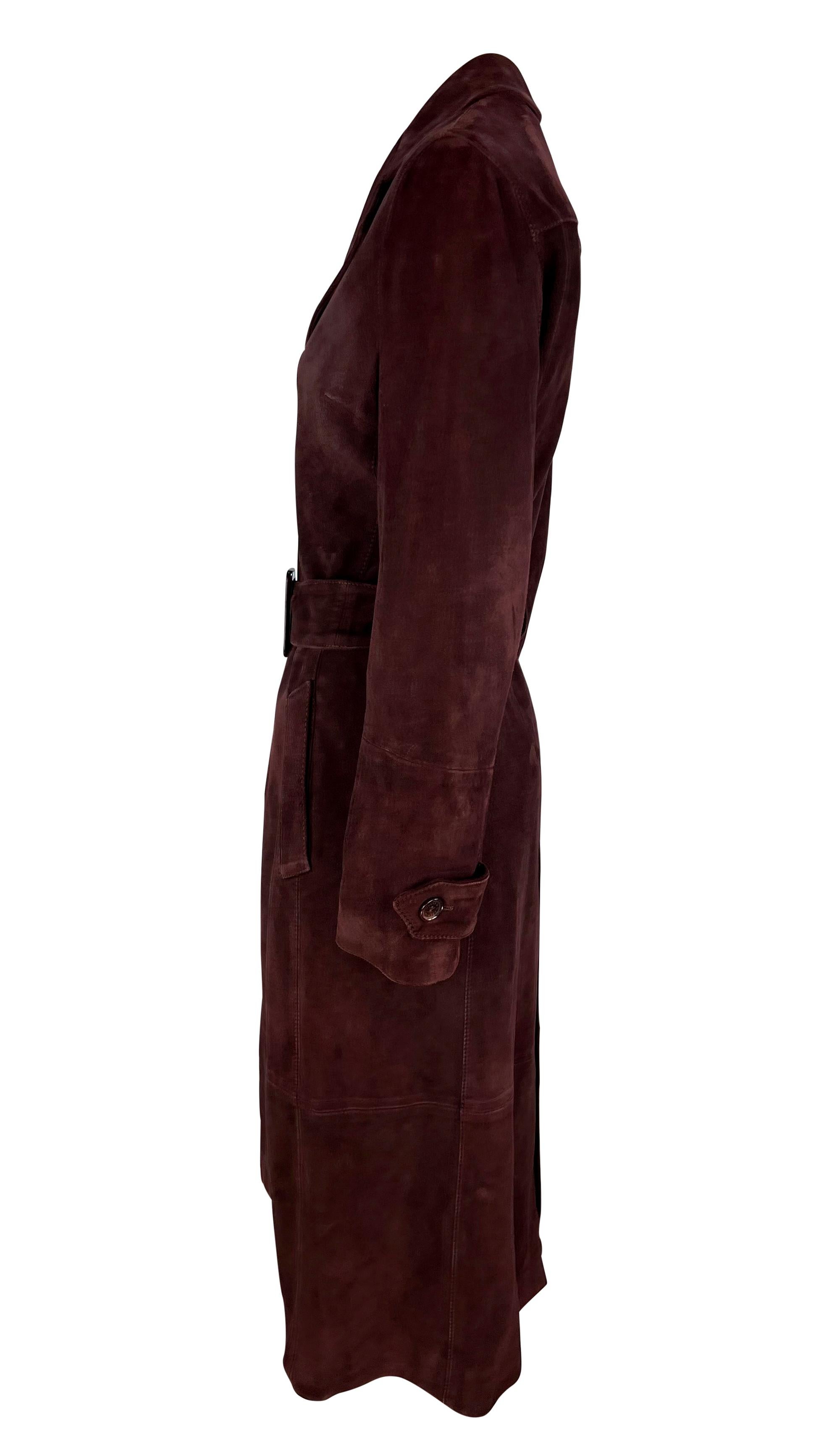 This early 2000s Dolce & Gabbana coat is crafted entirely from burgundy suede and comes with a matching wide waist belt. It features a fold-over collar, button closures, and pockets at each hip

Approximate measurements:
Size - 42IT
Shoulder to hem: