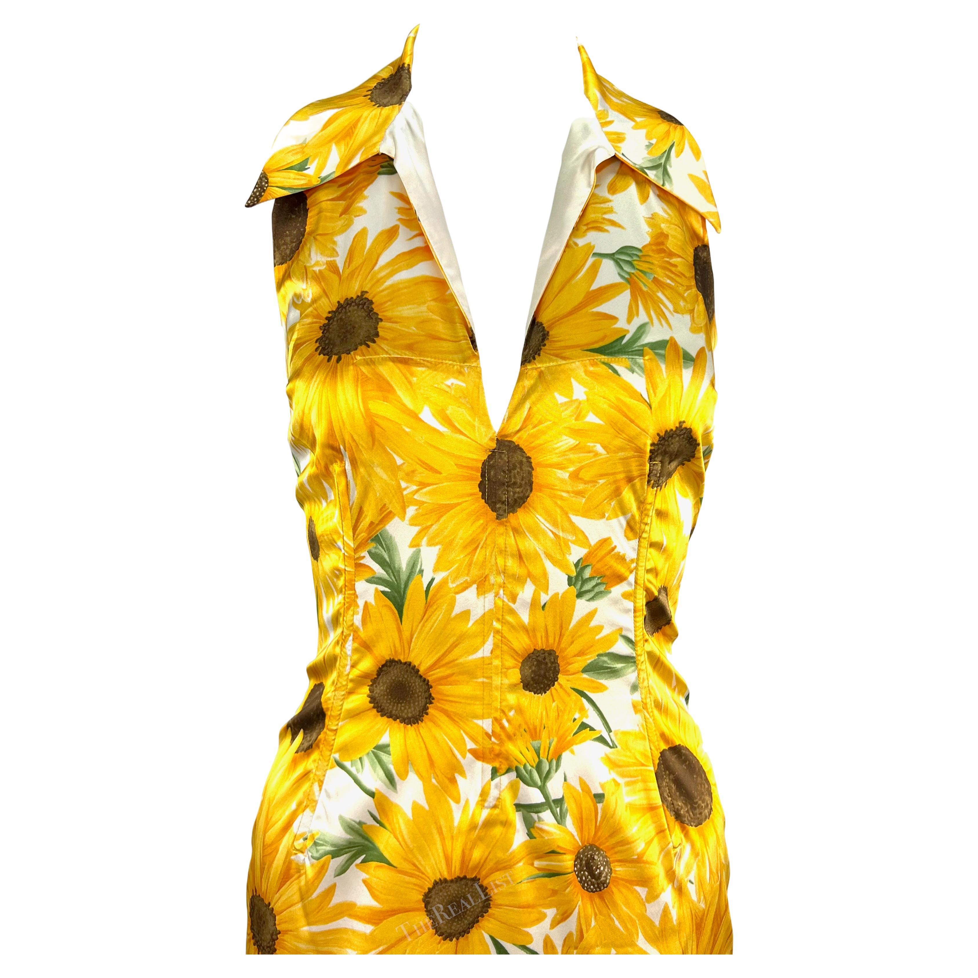 Presenting a gorgeous yellow sunflower print Dolce & Gabbana halterneck dress. From the early 2000s, this satin halterneck style dress features a v-neckline, fold-over collar, semi-exposed back, and internal boning at the waist. The lustrous dress
