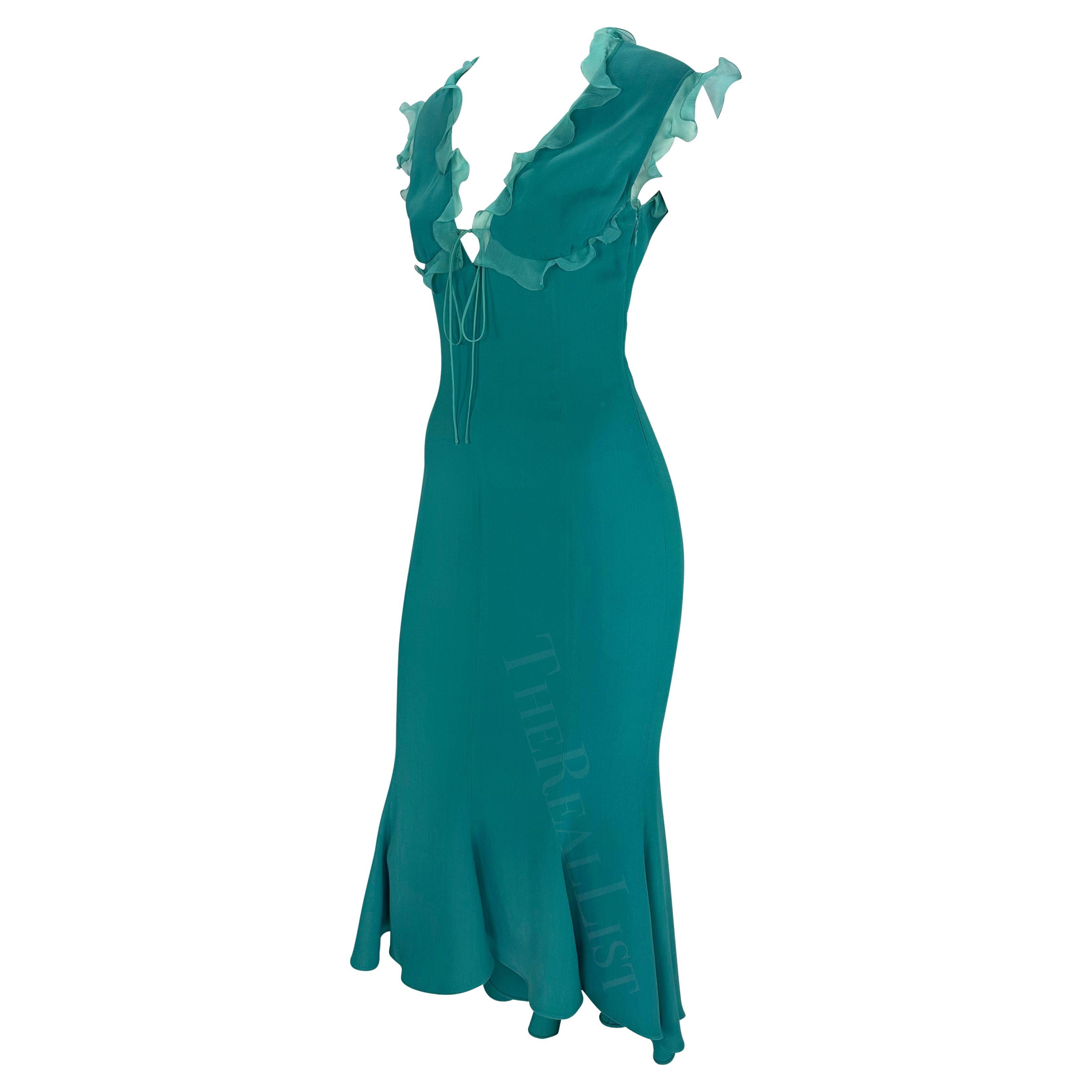 Presenting a beautiful teal Emanuel Ungaro midi dress. From the early 2000s, this dress is accented with chiffon ruffle details at the top and is made complete with a trumpet-style hem. This sexy Y2K dress is the perfect addition to any