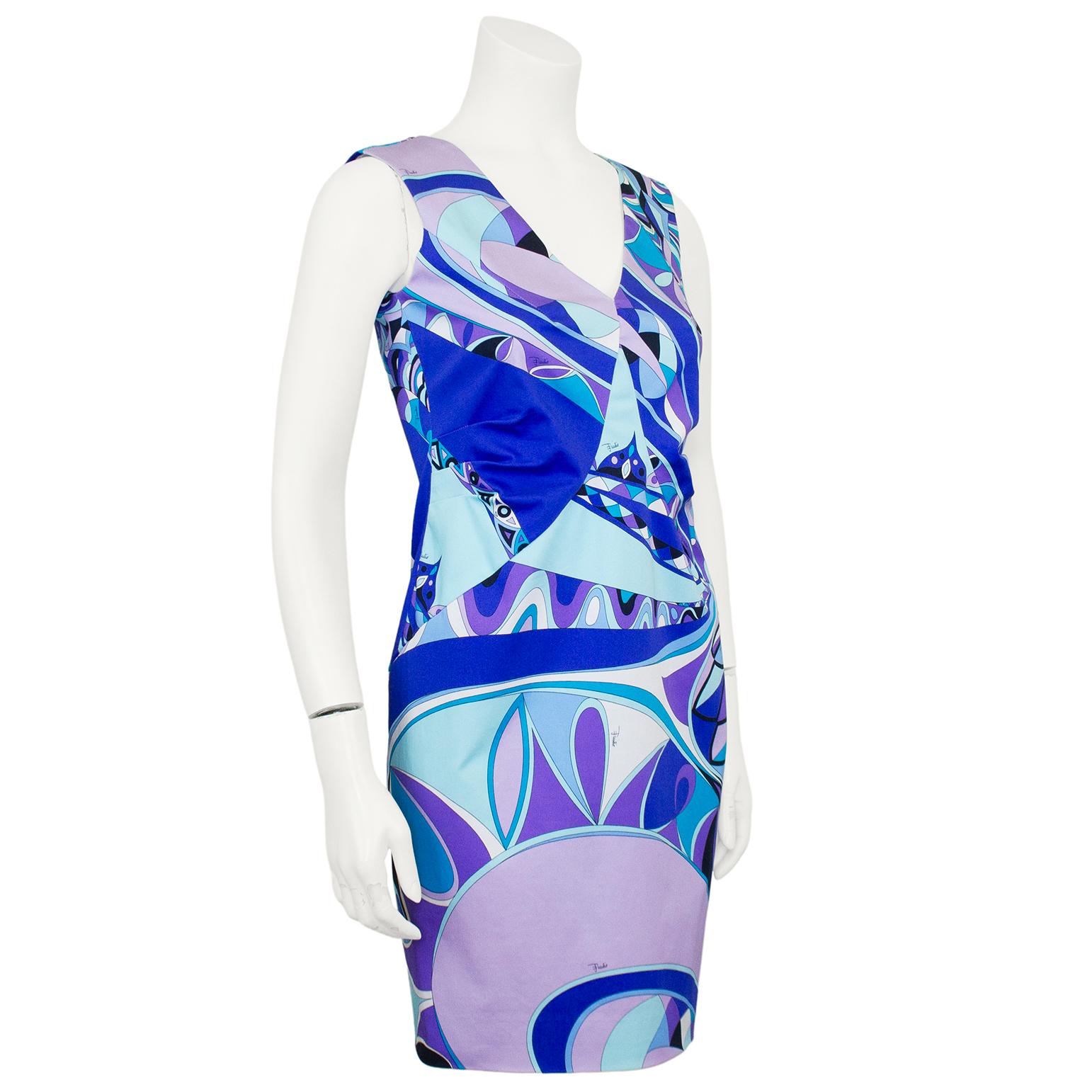 Visual and vibrant Emilio Pucci dress from the early 2000. Allover geometric printed cotton in shades of turquoise, blue and purple with accents of black and white. Sleeveless with v neckline and some pleating through the waist. The cotton has a
