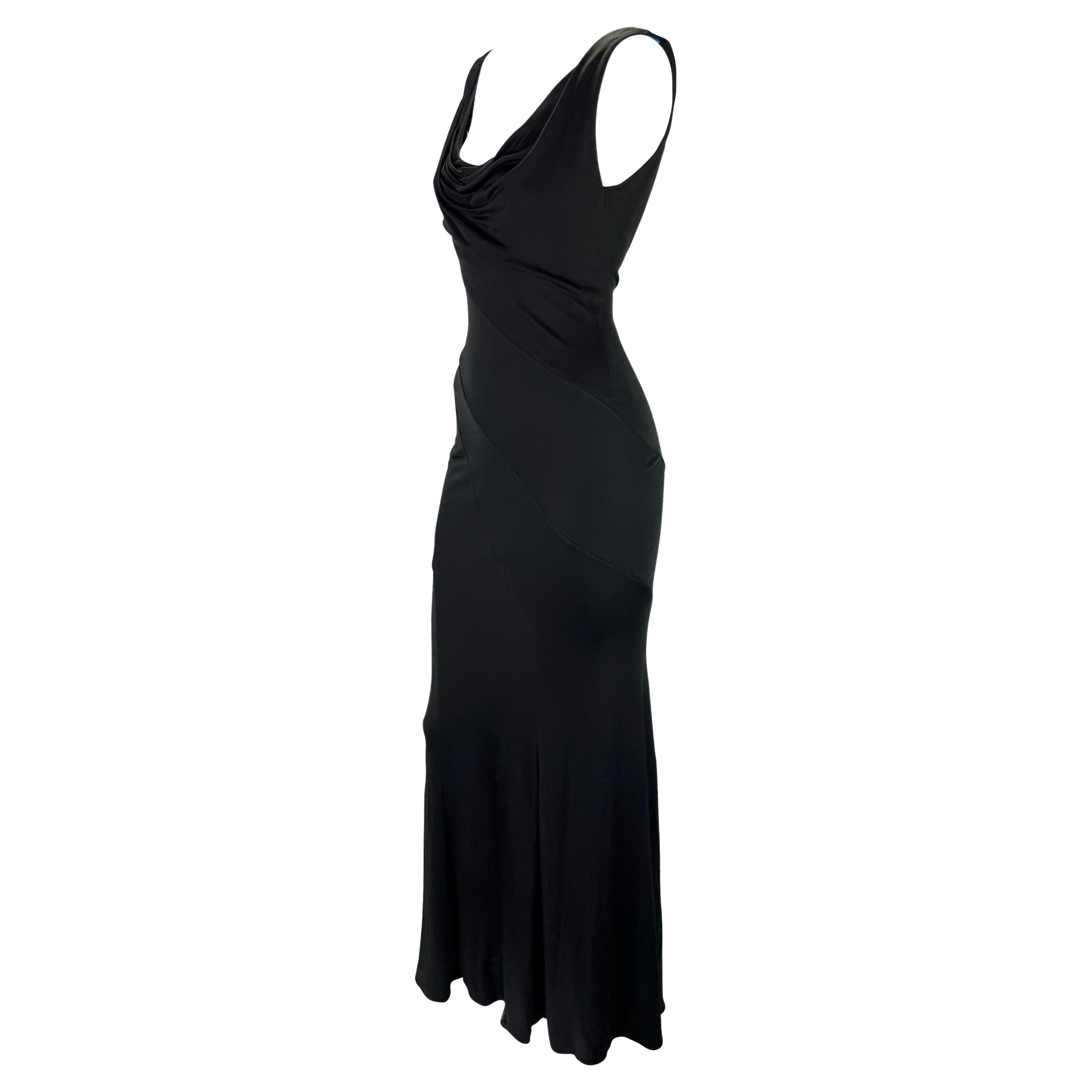 Presenting a beautiful black Gianni Versace Couture gown, designed by Donatella Versace. From the early 2000s, this effortlessly chic and sexy gown features a cowl neckline and an exposed back. The form-fitting dress is made complete with panels