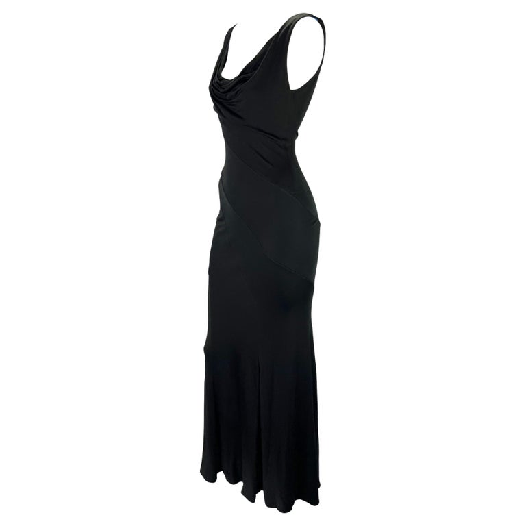 TheRealList presents: a beautiful black Gianni Versace Couture gown, designed by Donatella Versace. From the early 2000s, this effortlessly chic and sexy gown features a cowl neckline and an exposed back. The form-fitting dress is made complete with