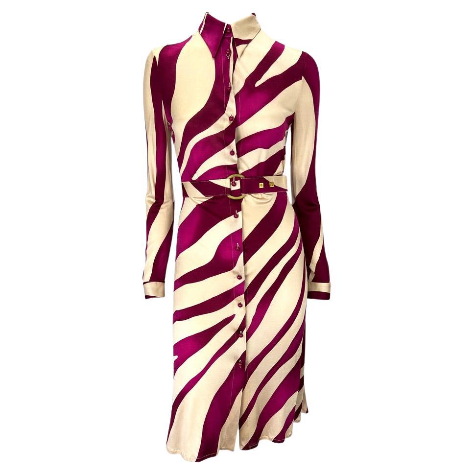 Presenting a beautiful collared button down Gianni Versace Couture tiger print dress, designed by Donatella Versace. Constructed entirely of pink and beige tiger print silk, this button down dress features long sleeves, a standard collar, and a