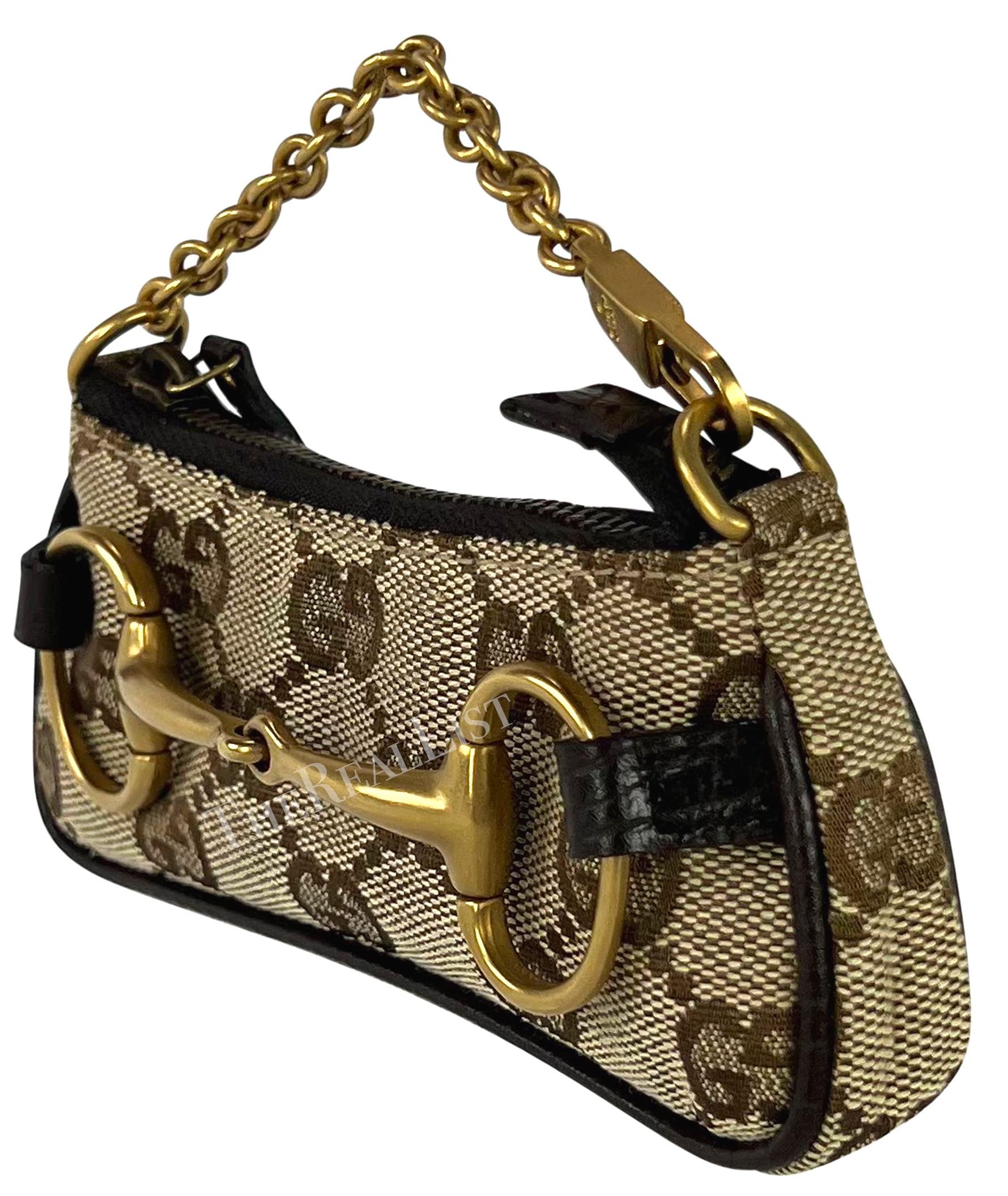 Presenting a petite brown Gucci monogram canvas horse-bit bag/coin purse designed by Tom Ford from the early 2000s. This fabulous micro bag embodies Ford’s iconic horse bit style shoulder bag, a design that has recently been reintroduced.The bag can