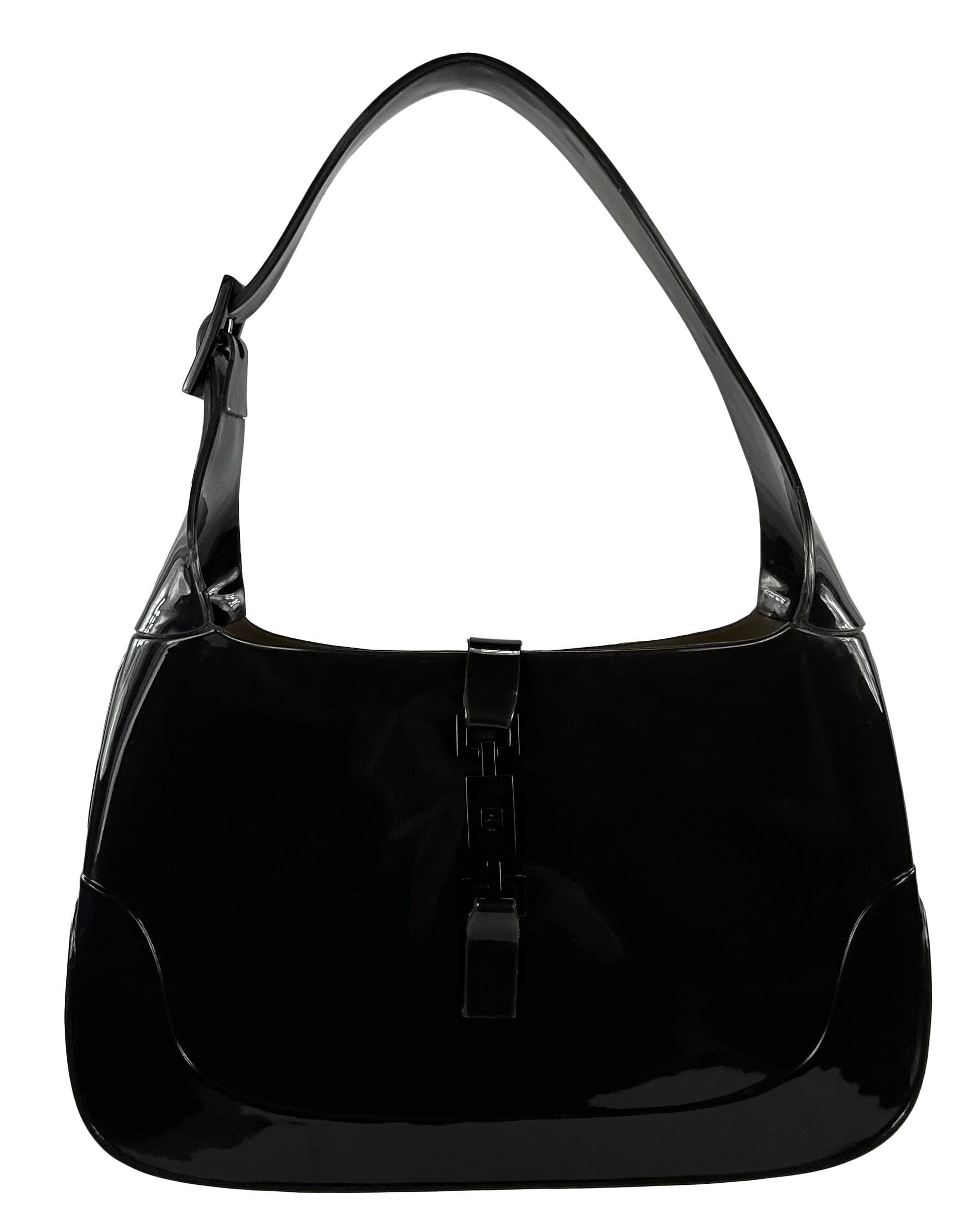 This ultra-rare charcoal grey Gucci rubber Jackie bag was designed by Tom Ford in the early 2000s. This classic and instantly recognizable bag is constructed entirely of glossy rubber and accented with dark gunmetal hardware. With its signature