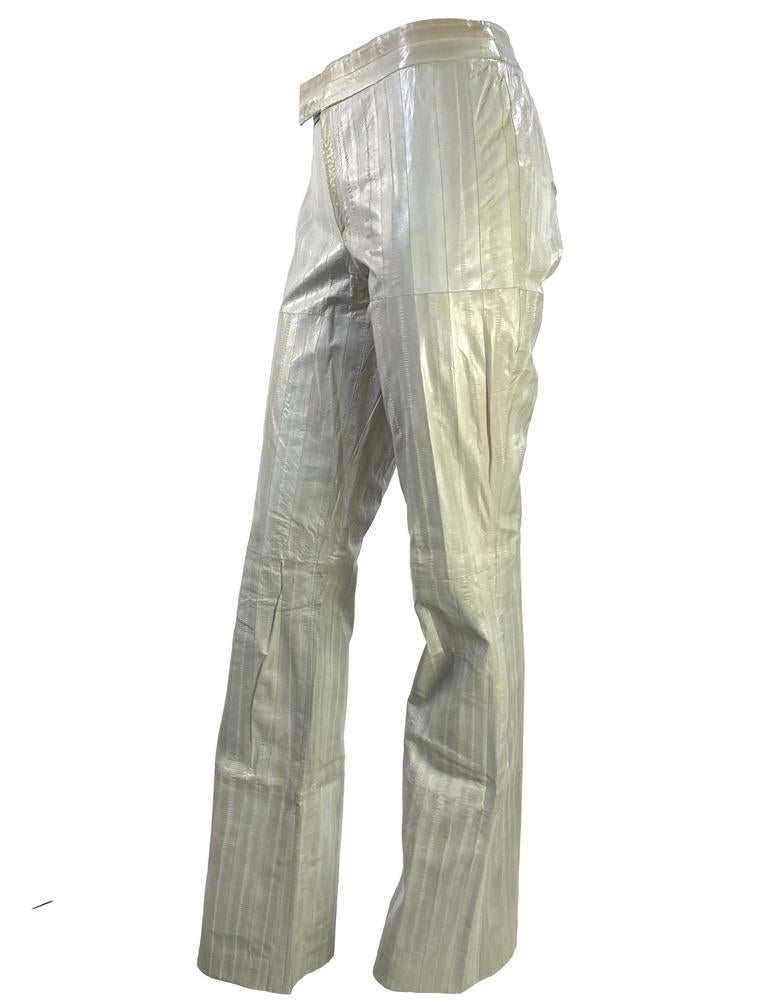 Presenting a fabulous pair of off white eel skin Gucci pants, designed by Tom Ford. Constructed entirely of eel hides, these semi-flared pants boast a creme/ off white with natural color variation from the eel skin. A rare find, these pants make a