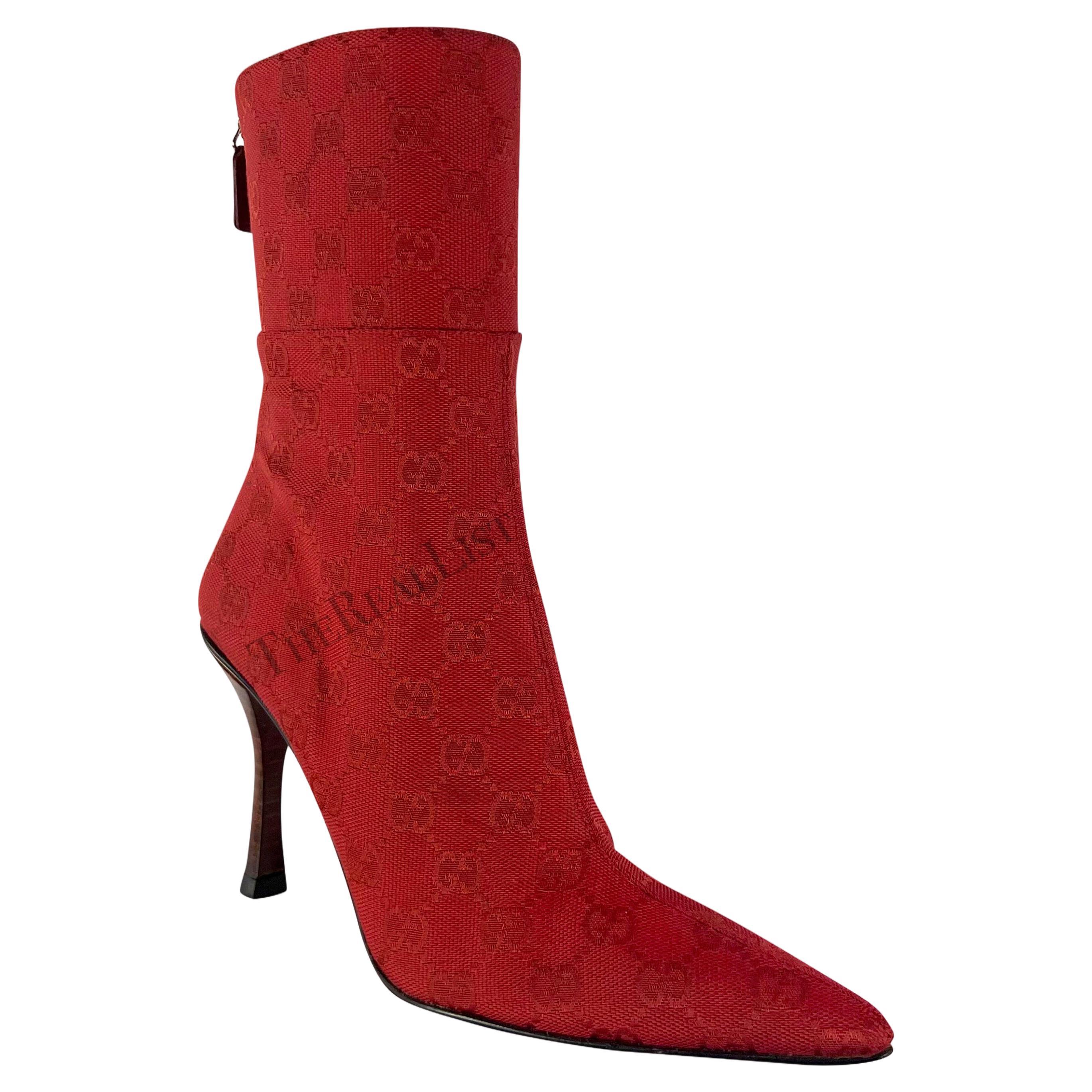 Presenting a pair of bright red canvas Gucci heeled boots, designed by Tom Ford. From the early 2000s, these heeled booties feature a pointed toe and are constructed entirely of Gucci 'GG' monogrammed canvas. 

Approximate measurements: 
Size -