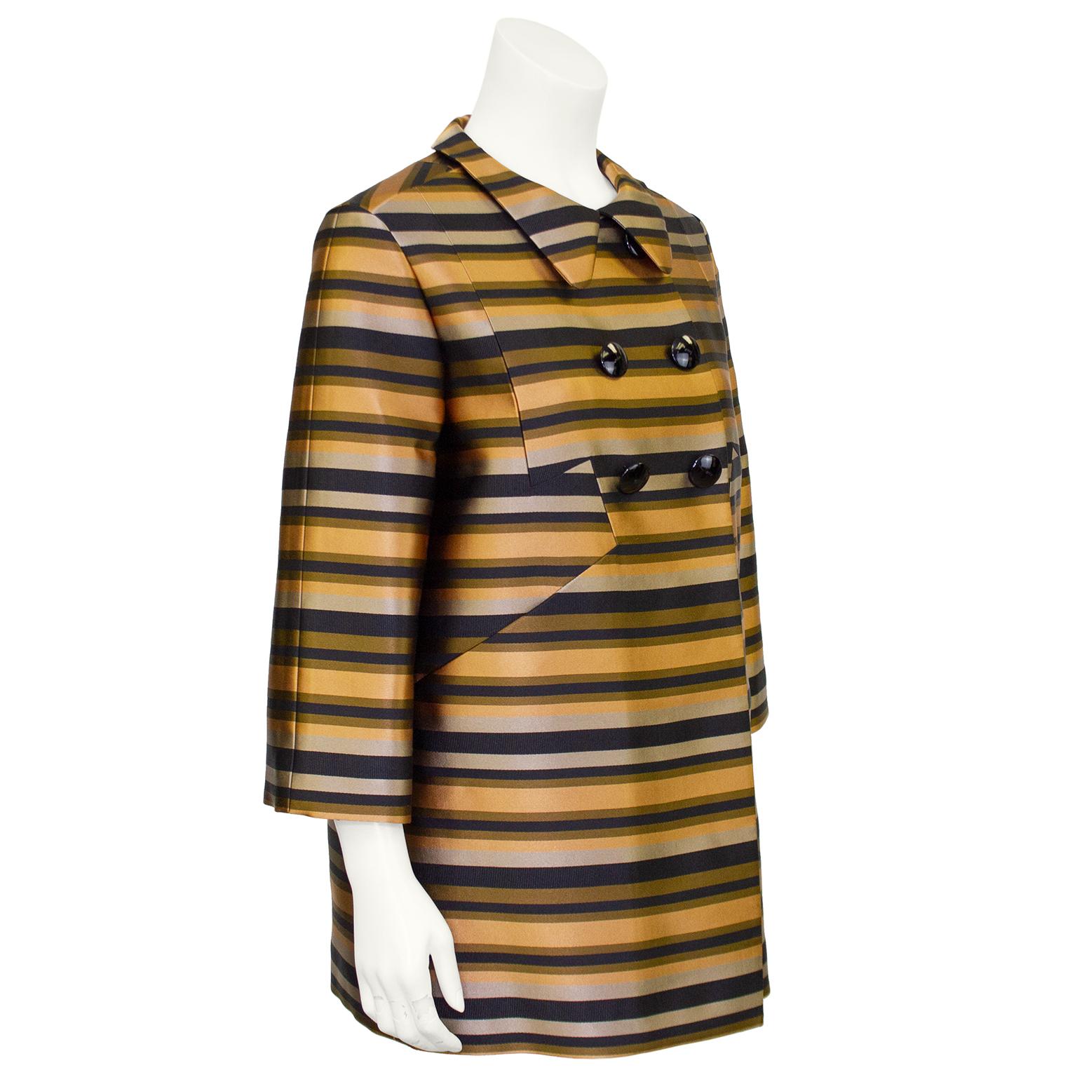 Incredibly stunning Louis Vuitton double breasted coat from the early 2000s. Lucious silk and grosgrain tan, bronze, black and grey horizontal stripes with a Peter Pan collar and bracelet length sleeves. Expertly crafted cut work at yolk that gives