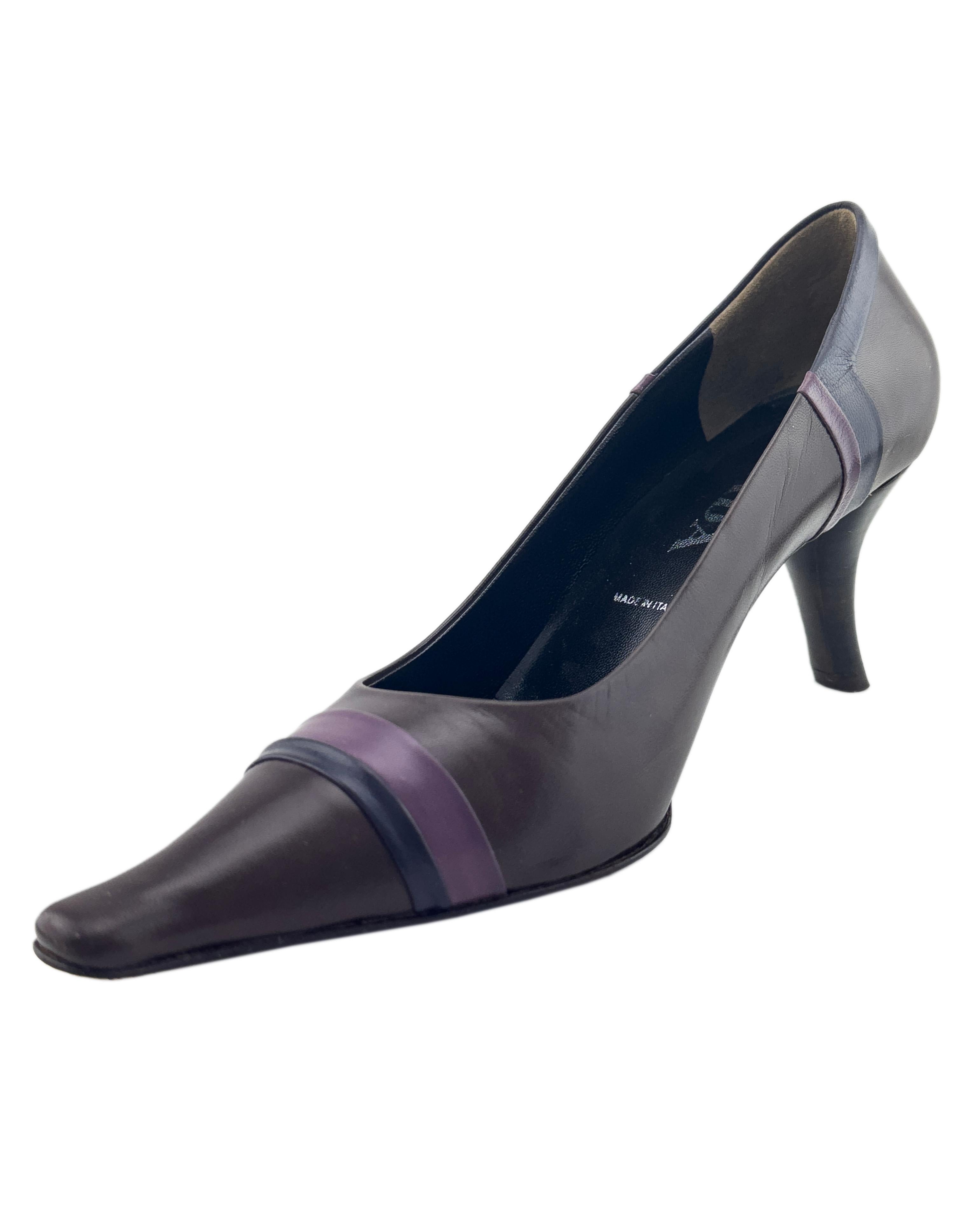 Prada pumps from the early 2000s. Chocolate brown leather with light and dark purple leather stripe details. Amazing shape with an elongated slightly rounded square toes and comma shaped kitten heel. Black leather interior. Excellent vintage