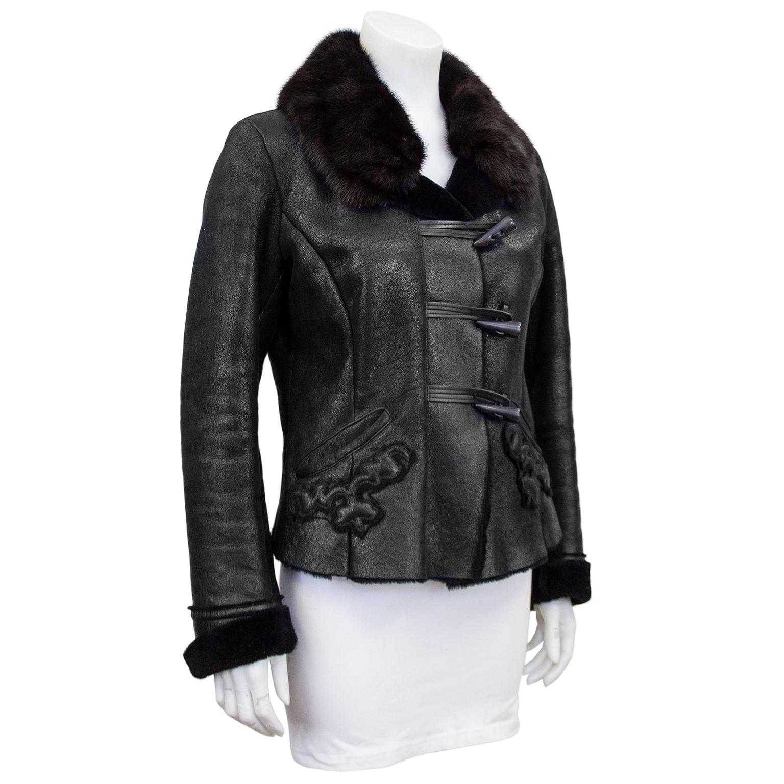 Stunning early 2000's black shearling Prada fitted cropped jacket with faux bone toggles up the front and  trapunto raised embroidered details on the front two angled pockets. Notched luxurious collar, deep black long hair shearling. In excellent