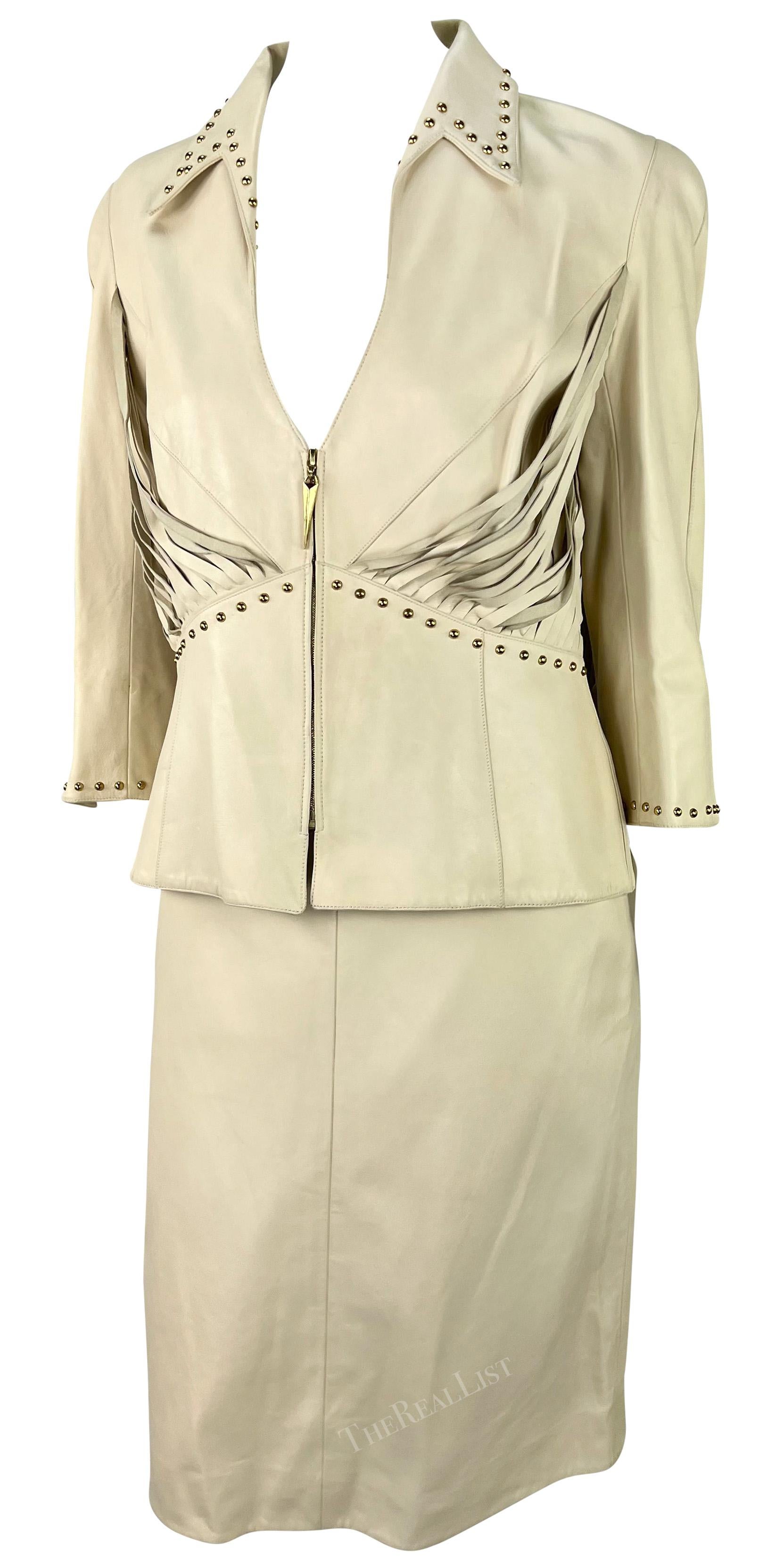 This cream-colored leather skirt set by Thierry Mugler, designed by Manfred Mugler, comes from the early 2000s. It includes a pencil skirt and a matching jacket, both made entirely of leather. The jacket has a plunging neckline, cropped sleeves, and