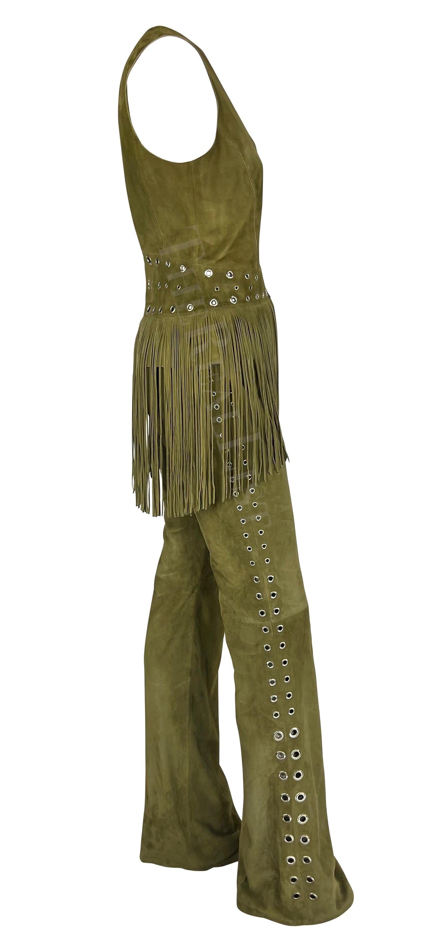 Presenting an olive green suede Thierry Mugler vest and pant set, designed by Manfred Mugler. From the early 2000s, both the pants and vest are accented with silver-tone grommets. The pants feature a flared cut with grommets on either leg that