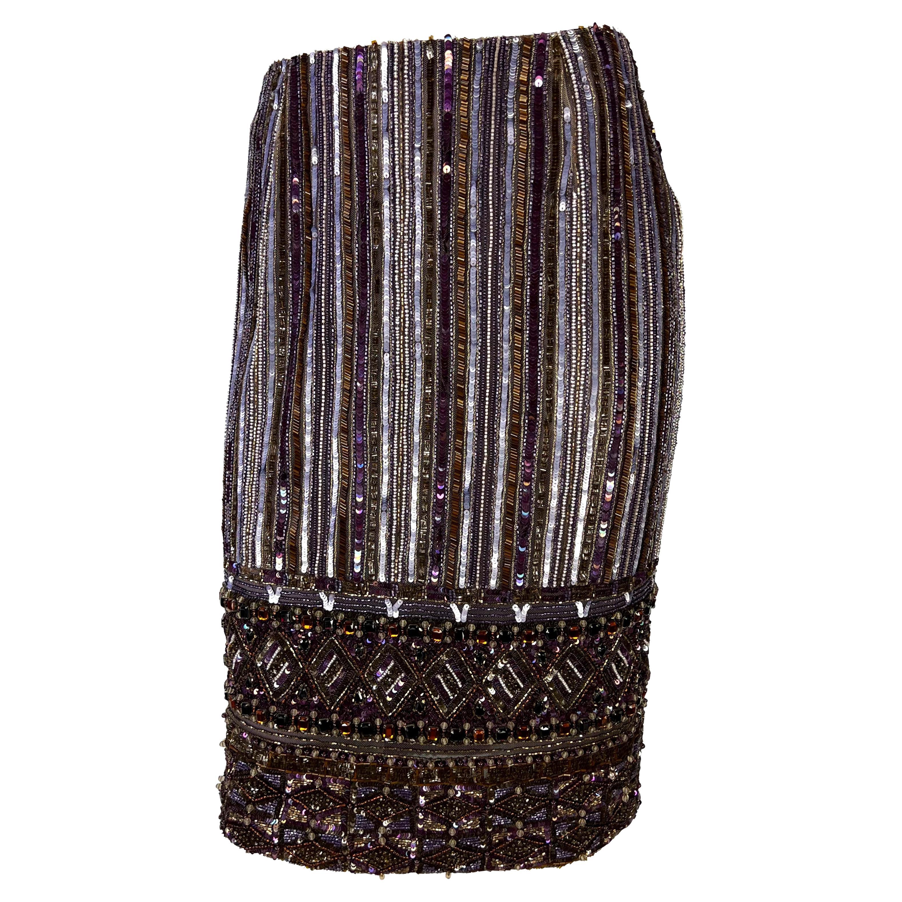 Presenting a beautiful deep purple rhinestone and beaded Valentino skirt. From the early 2000s, this intricate hand-beaded skirt is covered in thousands of beads and rhinestones. The skirt features a vertical stripe pattern around the rear with a