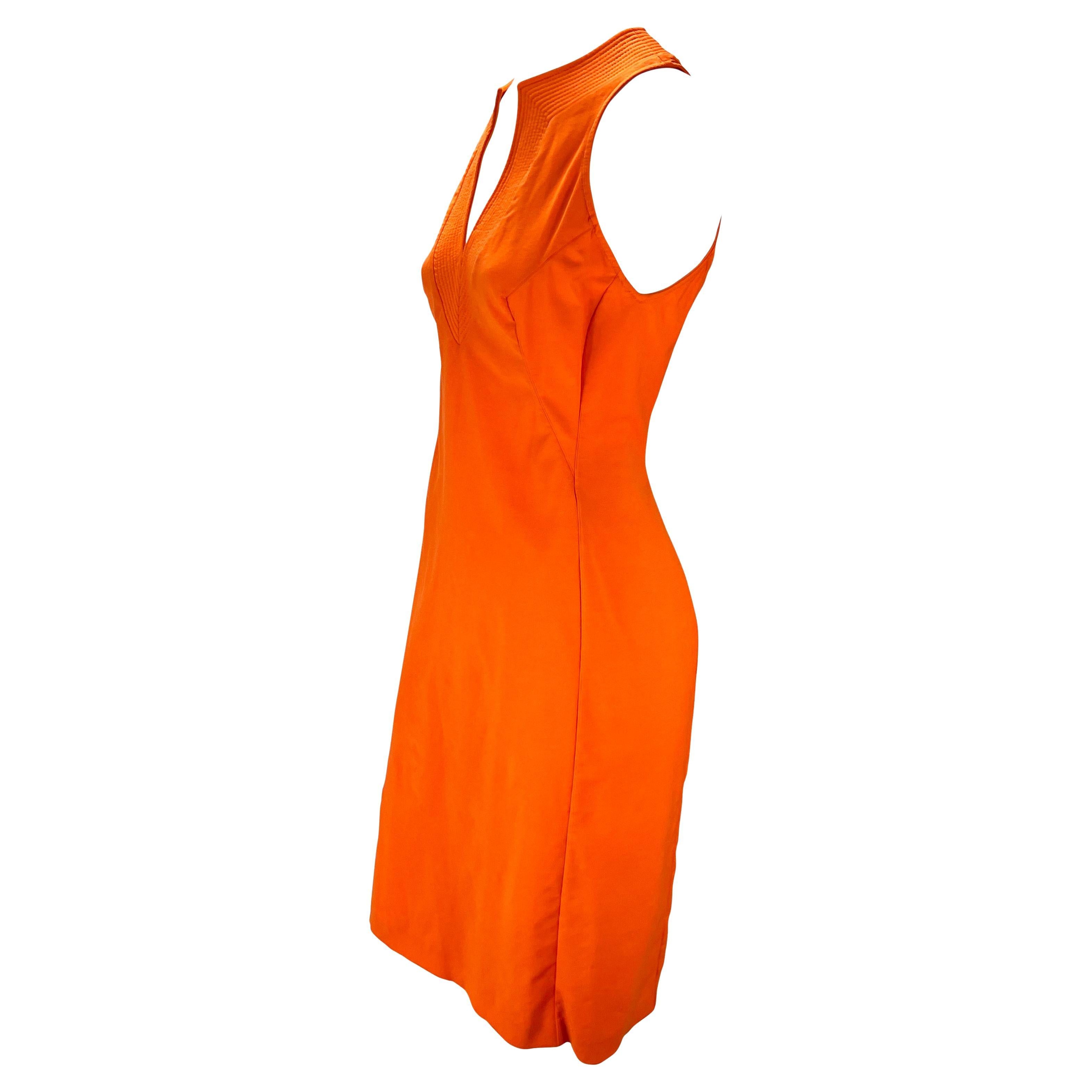 Presenting a stunning bright orange Versace dress, designed by Donatella Versace. From the the early 2000s, this beautiful sleeveless dress features quilting around the deep v-neckline. Lively and effortlessly chic, this dress will become a