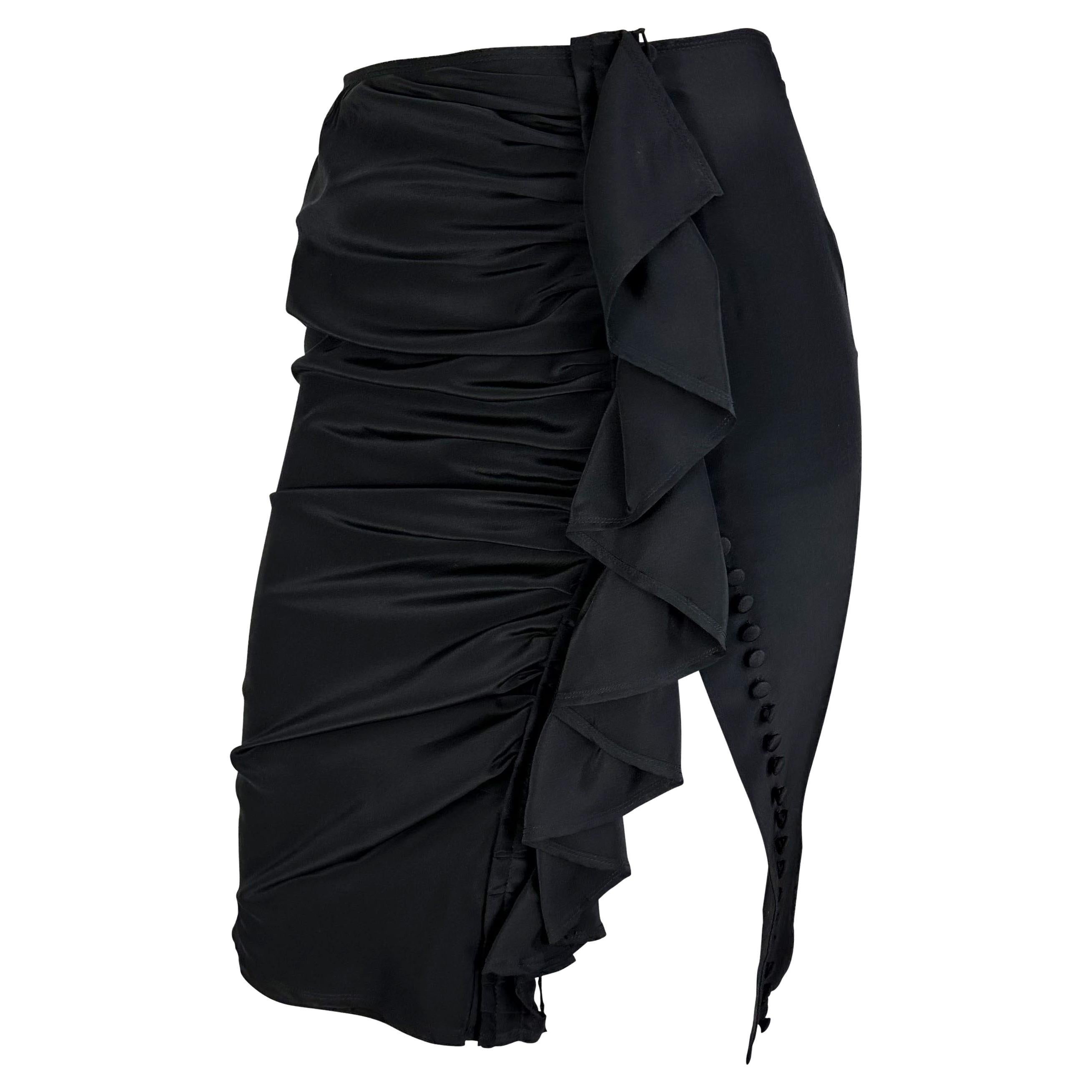 Presenting an incredible black silk Yves Saint Laurent Rive Gauche skirt designed by Tom Ford. From the early 2000s, this skirt features ruching at the front, a vertical ruffle detail, and a top-to-bottom button closure. Add this fabulous and