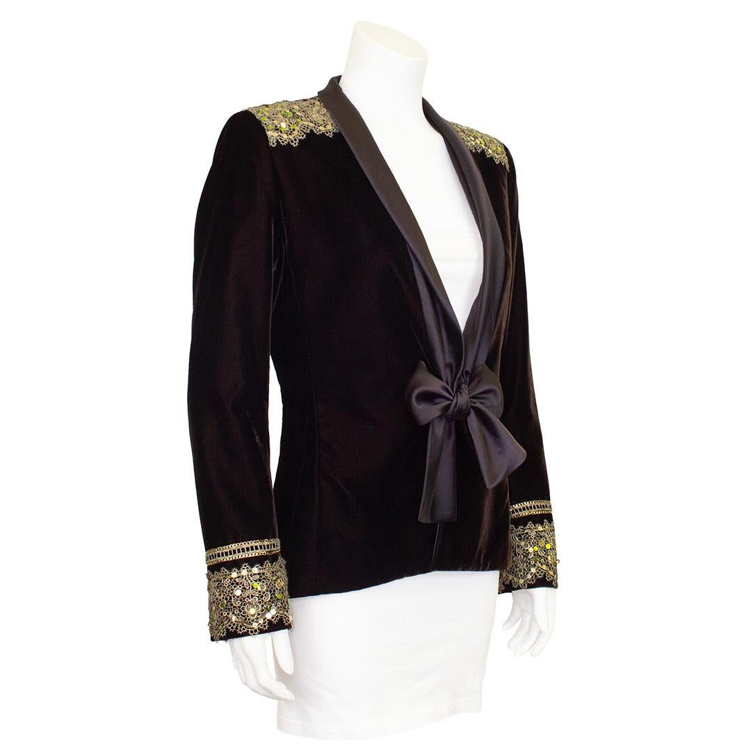 Stunning and fabulous YSL evening jacket from the early 2000s. Lucious chocolate brown velvet with a loose silk satin collar that ties at the centre waist. The jacket is embellished with complementary Indian inspired gold embroidered and gold and
