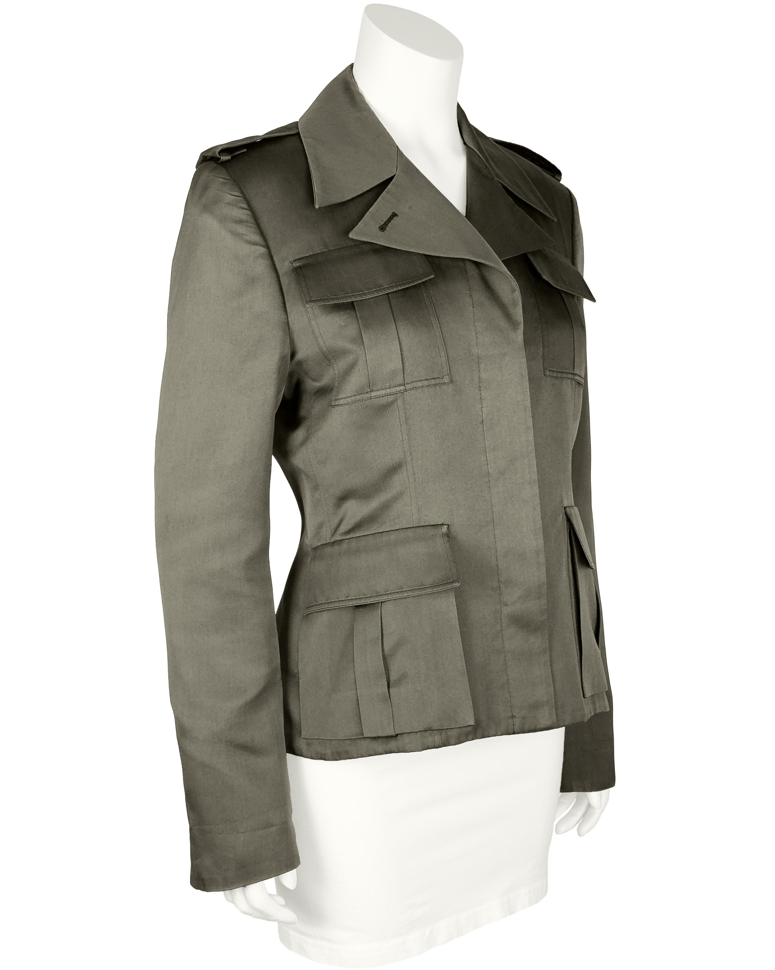 Chaqueta estilo safari de algodón de la Era Tom Ford de Gucci de principios de los 2000 en color oliva. Cierre frontal con botones ocultos bajo tapeta, cuatro bolsillos con solapa y pliegue central. Ajustado por la cintura. En excelente estado