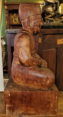 Early 20th Century Indonesian Carved Wooden Seated Gentleman
