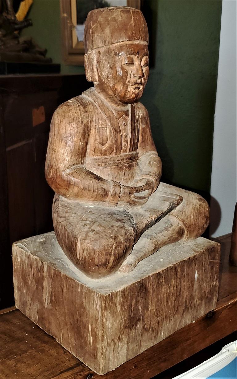 Hand-Carved Early 20th Century Indonesian Carved Wooden Seated Gentleman For Sale