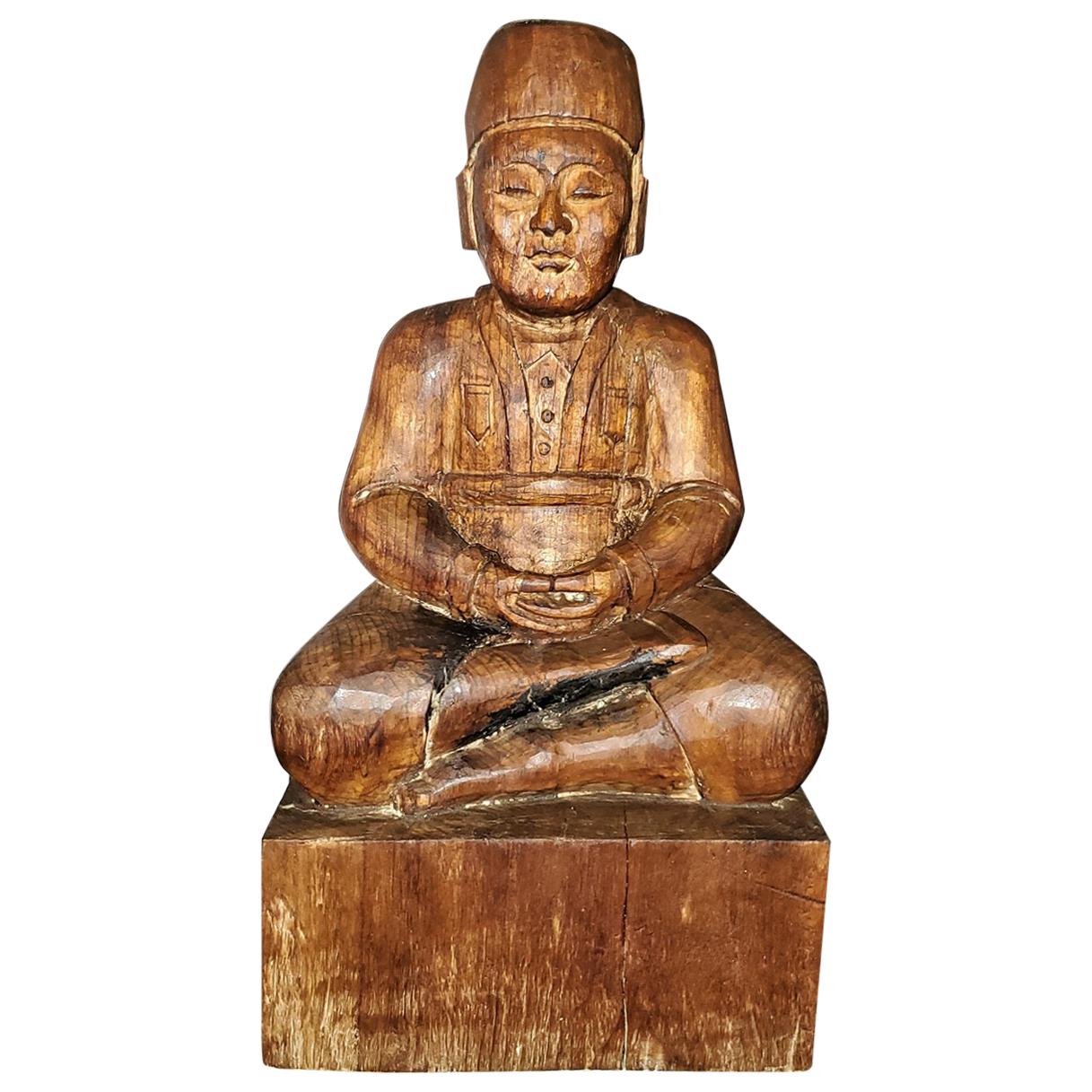 Early 20th Century Indonesian Carved Wooden Seated Gentleman