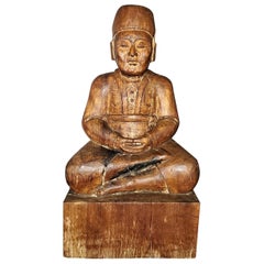 Early 20th Century Indonesian Carved Wooden Seated Gentleman