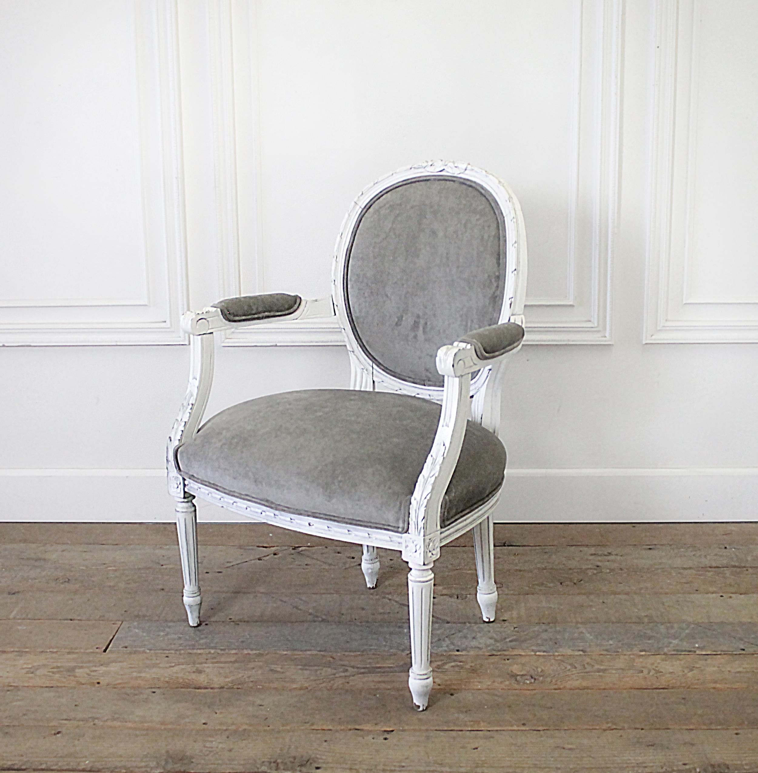 Early 20h century carved and painted French Louis XVI style open armchair
Painted in our antique white, with subtle distressed edges, and light antique glazed patina. This Louis Arm chair has been upholstered in a medium grey velvet.
Chair is