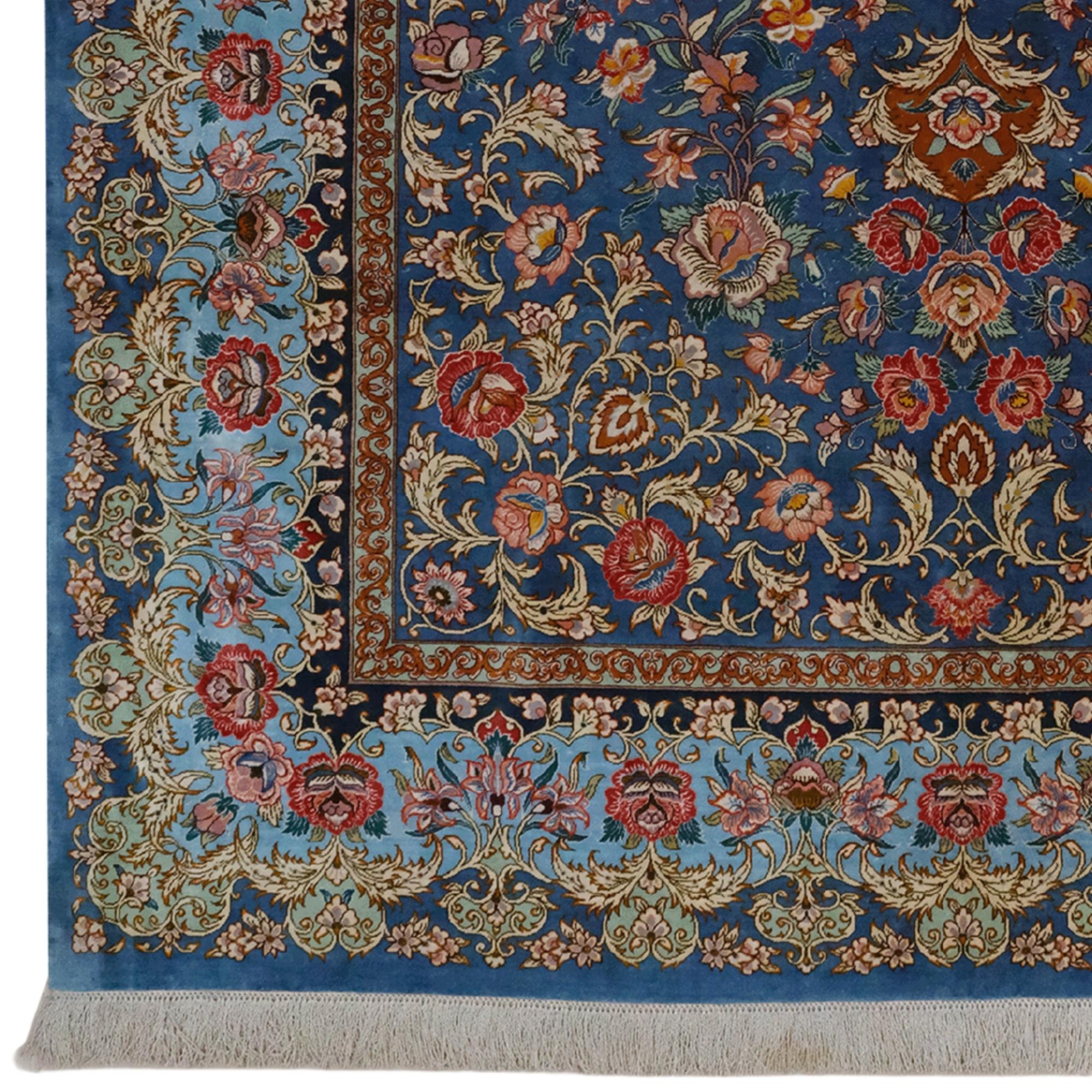 This unique antique Qum carpet, dating from the early 20th century, is a dazzling work of art with its hand-woven silk material. Rich dark blue tones, golden yellow details and delicate floral motifs make this carpet not only a decorative element