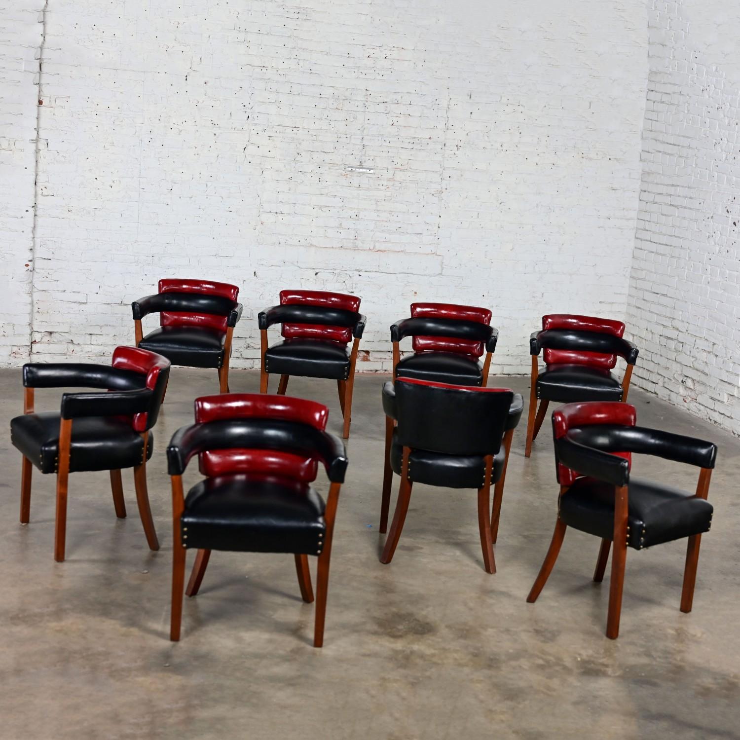 Fabulous vintage Art Deco dining chairs comprised of walnut toned wood frames with red & Black leather seats & backs with brass nail head detail styled after Donald Deskey, Paul Frankl, & Edward Wormley. Beautiful condition, keeping in mind that