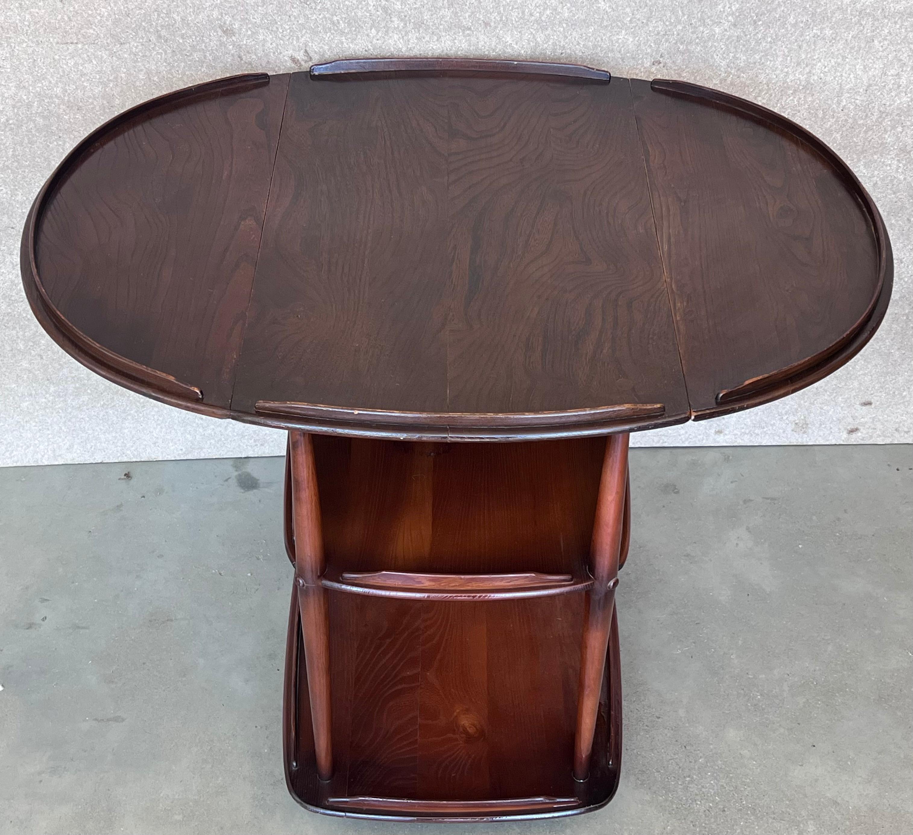 Very cool serving cart made from walnut with three trays. The two leafs are easily and quickly folding and the cart is convertible in a functional coffee tea or table that you love it. 
It has wheels that works perfectly.
The piece works perfectly