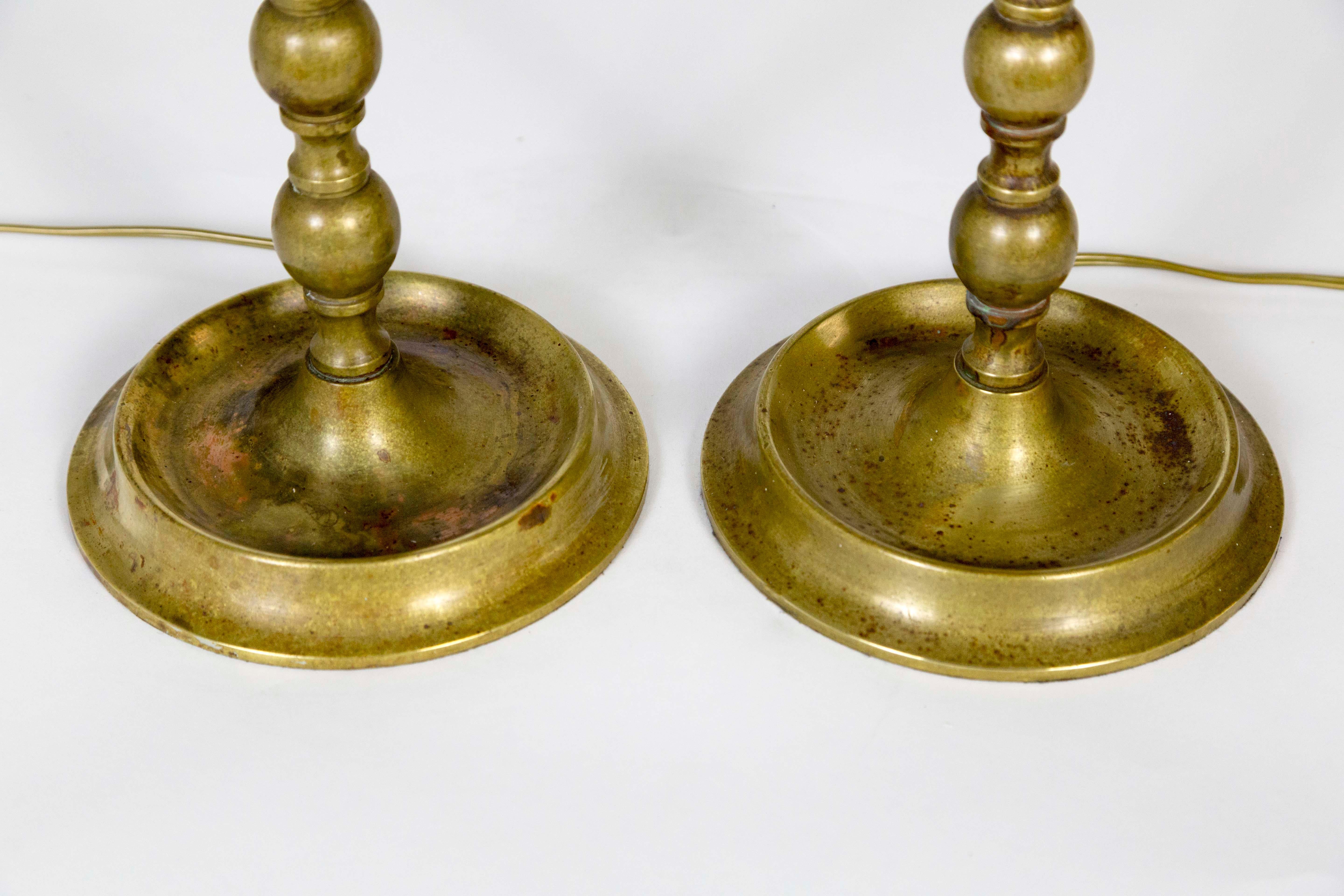 An elegant pair of solid brass, traditional, American Colonial candlesticks as lamps. 22” to top of the socket, base 6.5”diameter. Inline switch, circa 1915.