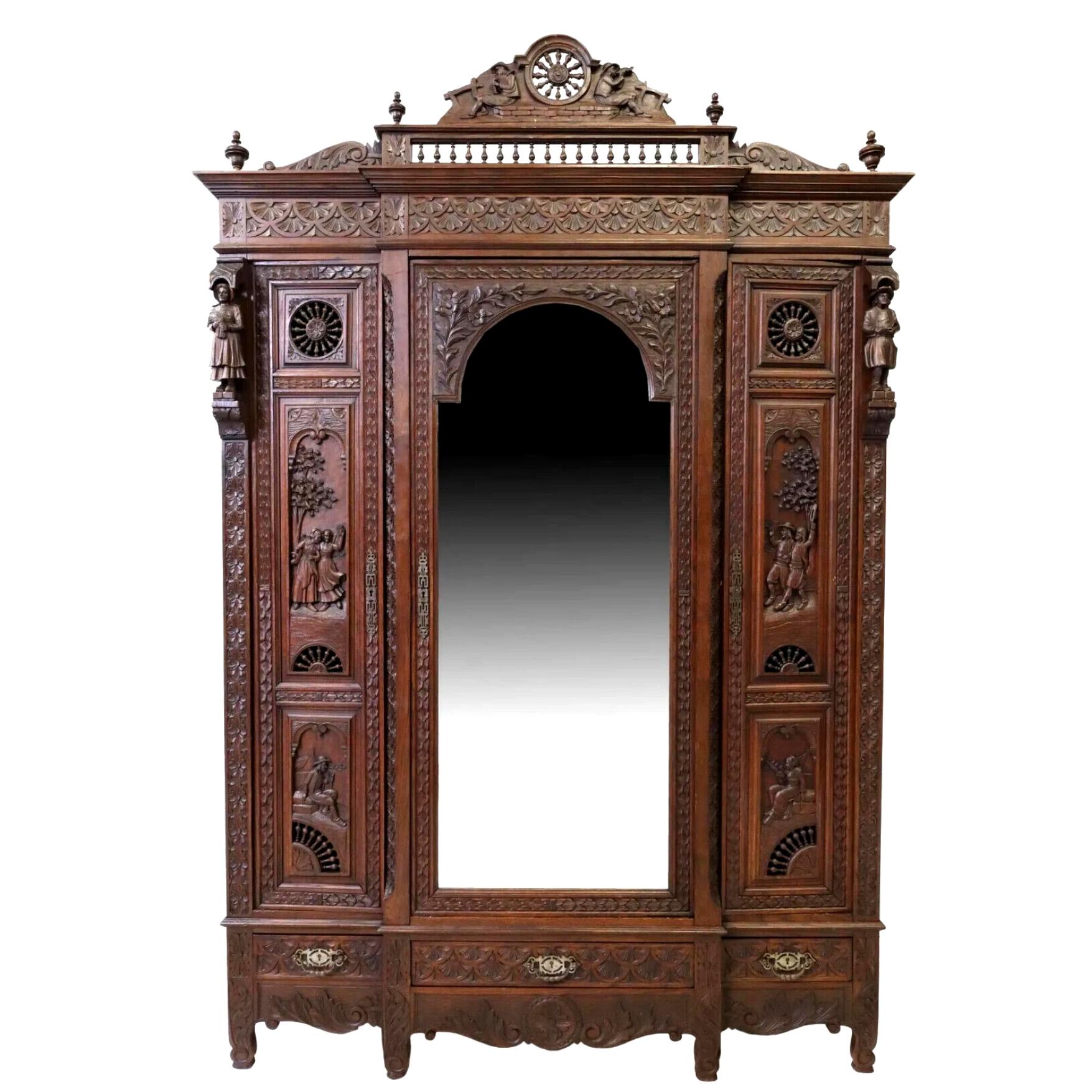 Gorgeous Antique Breakfront Armoire, Triple, French Breton, Carved Oak, Mirrored, Early 1900s, 20th century!

French carved oak breakfront armoire, Brittany, early 20th c., spindled wheel crest, figural carving, three doors, center door faced with